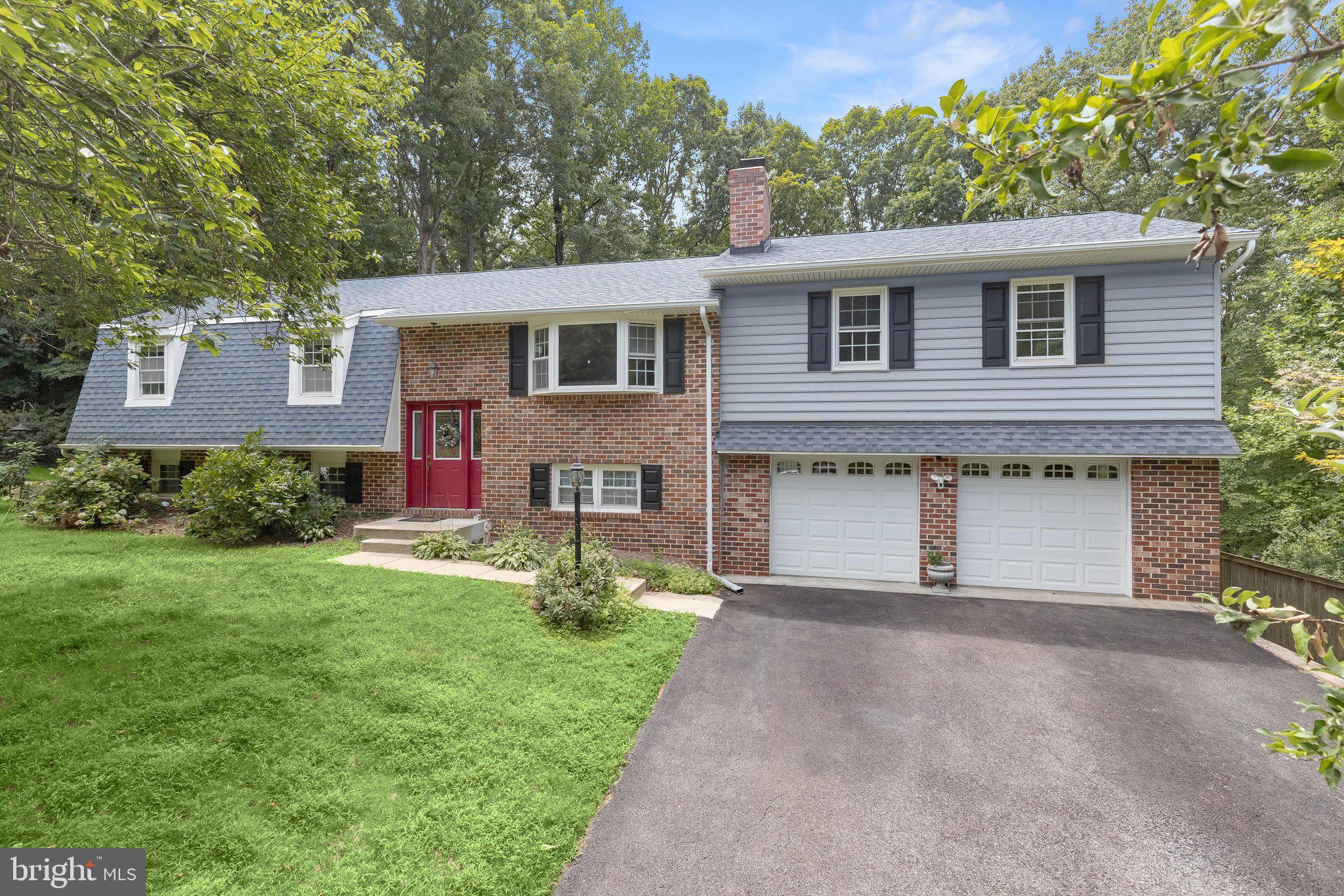 Nestled on a picturesque one acre lot surrounded by mature landscaping and peaceful wooded views, this spacious four bedroom, 2-full and 2-half bath home offers a thoughtfully designed layout, inviting indoor living spaces, and outdoor amenities. The sprawling property immediately impresses with its expansive setting and beautiful surroundings, offering a welcoming introduction to this residence. Hardwood flooring and a bright bay window highlight the living room, where French doors open to the dining area and kitchen, creating an easy flow for both everyday living and entertaining. Designed with style and functionality in mind, the kitchen features ceiling height cabinetry, stainless steel appliances, a sleek range hood, a pantry with roll out shelves, and a dining area with a sliding glass door leading to the deck, where tranquil views of the surrounding trees await.
Just a few steps above, the light filled family room offers a comfortable gathering space enhanced by a Palladian window, skylight, and an atrium door with sidelights that opens to a private balcony. This level also includes a bedroom and a den/study along with a convenient half bath that serves this side of the home.
The primary suite provides a relaxing retreat with two closets, private access to the deck overlooking the wooded setting, and an en suite bath featuring a tiled shower. Two more bedrooms are situated on this side of the home and share a full bath with a soaking tub and shower combination.
The lower level expands the home's living space with a spacious recreation room centered around a charming brick surround stove. A sliding glass door provides direct access to the backyard, while access to the 2-car garage and another convenient half bath add everyday functionality. The laundry room with utility space, abundant storage, and a cedar closet completes the lower level.
Outdoor living is equally impressive with a large deck with retractable awning overlooking the private backyard and an in ground pool and patio creating an ideal setting for relaxing afternoons and summer entertaining.
Hallmark Woods is an established community of spacious homes on scenic one acre wooded homesites, offering a peaceful setting with no through traffic. Residents enjoy easy access to nearby parks, golf courses, shopping, dining, Waugh Chapel Towne Centre, Fort Meade, Annapolis, and major commuter routes including MD 3, MD 32, and Route 50, providing an exceptional balance of privacy and convenience.