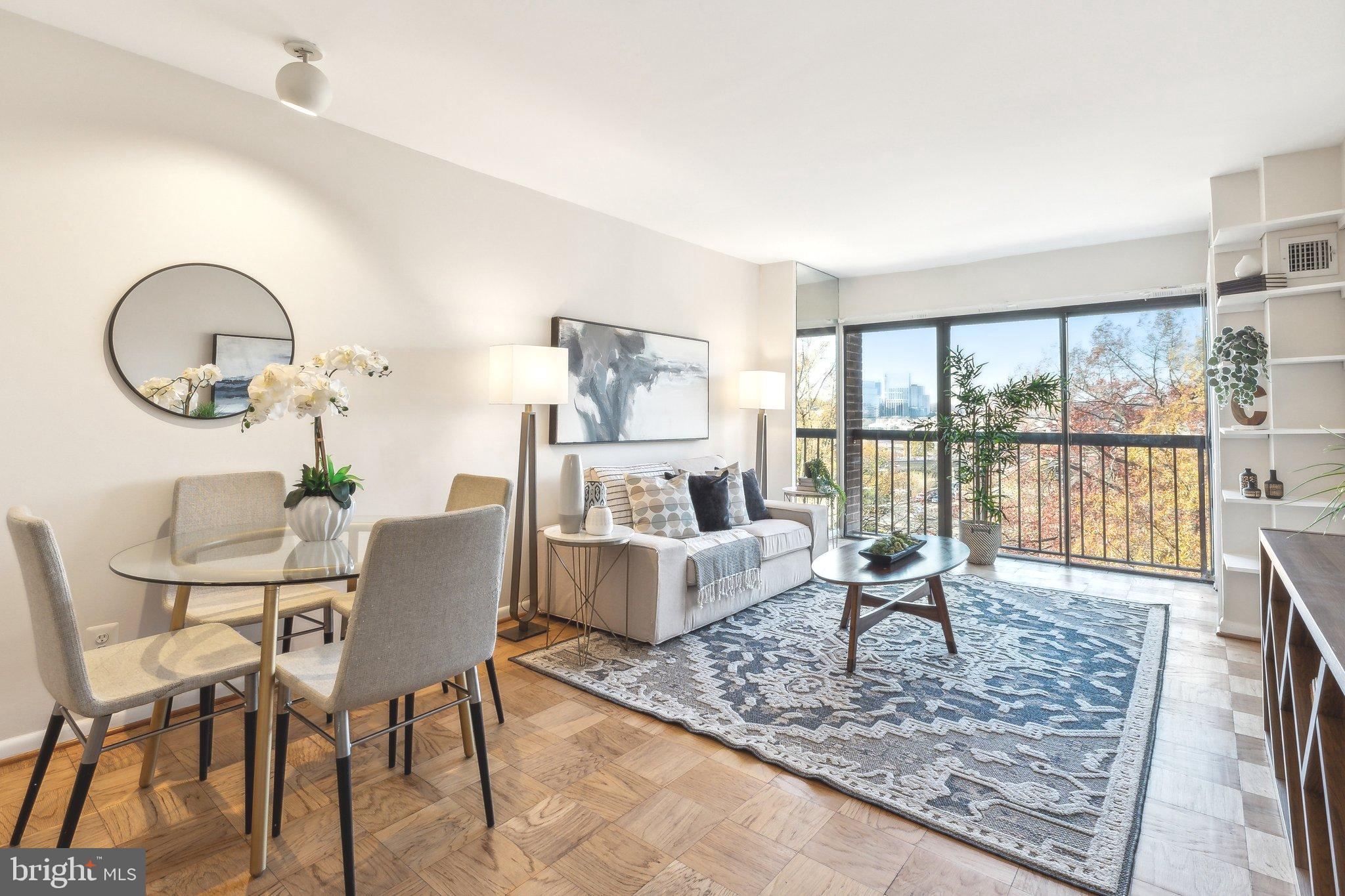 BRIGHT & OPEN CONDO WITH STUNNING CITY VIEWS AND AVAILABLE GARAGE PARKING IN FOGGY BOTTOM! Located in popular Foggy Bottom, this 1BR + DEN condo features hardwood flooring, tall ceilings, and neutral paint throughout. You'll love relaxing or entertaining in the spacious living room with the nearly floor-to-ceiling windows and a Juliet balcony to allow the fresh breeze to come in during the warmer months. PLUS, this condo has some of the BEST UNOBSTRUCTED CITY VIEWS of Foggy Bottom, the Key Bridge and Potomac River, Georgetown, and Rosslyn, VA off in the distance. Off the living room, there is an area for dining and is conveniently located to the open kitchen that features BRAND NEW STAINLESS APPLIANCES, white cabinets with new hardware, and ample counter and cabinet space for storage. There is also a closet with an IN-UNIT WASHER & DRYER and some additional storage space. Near the front entrance of the condo, you'll find a DEN that is the perfect space for a home office, reading nook, or home gym. The bedroom is tucked away for ultimate privacy and also has a Juliet balcony and nearly floor-to-ceiling windows for stellar city views. The full bathroom is near the bedroom and has an extra-long granite vanity, large mirror, and nice storage space. A RESERVED GARAGE PARKING SPACE is also available for an additional cost. The building is PET-FRIENDLY, has on-site management, and a community ROOFTOP DECK WITH 360 DEGREE CITY VIEWS and several seating areas. You'll LOVE THE LOCATION - just minutes to downtown Georgetown, Metro, Whole Foods, George Washington University, Kennedy Center, playgrounds and a dog park, and a plethora of dining and entertainment options.