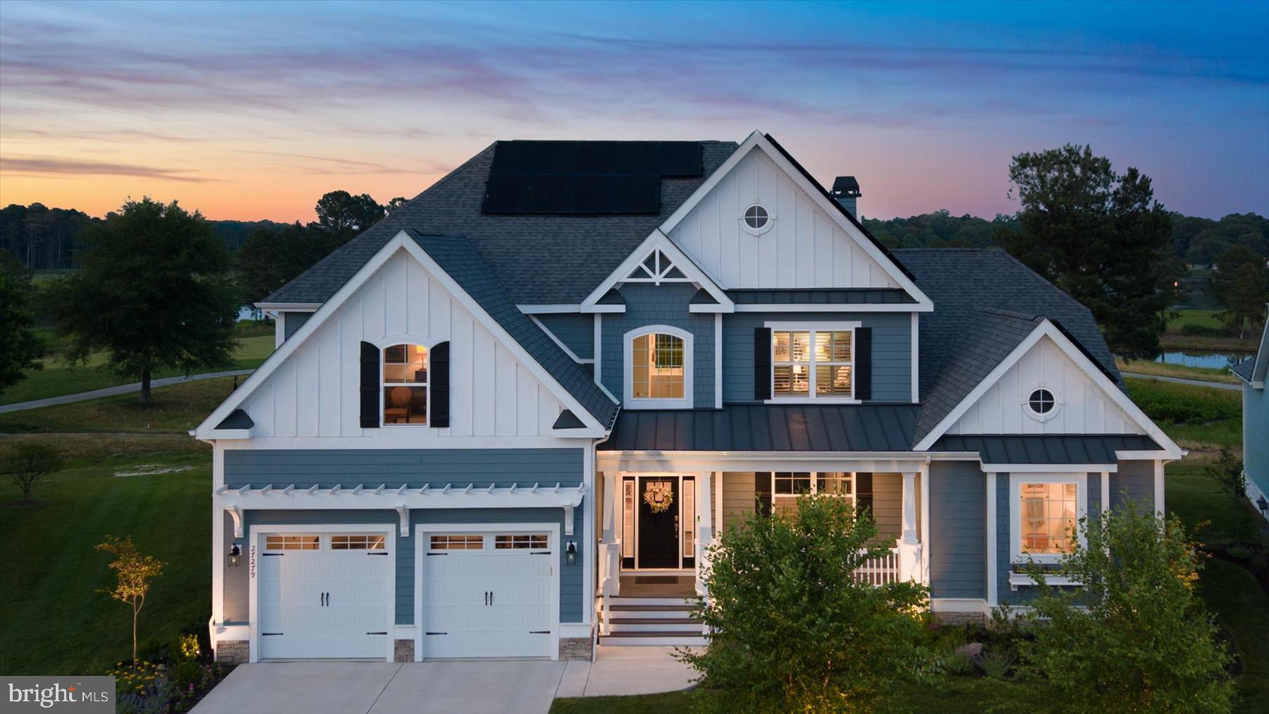 If you’ve been searching for that contemporary, coastal, custom home that can easily host a multi-generational family reunion and yet can easily be enjoyed as a cozy and intimate retreat, perfect for a couple’s relaxed life-style, welcome home. Ideally sited on a coveted premium lot with expansive water views of protected wetlands and the Peninsula’s championship golf course, this sensitively designed home marries distinctive architectural features with nature’s beauty, offering a front row seat for close-ups of Delaware’s native wildlife.
The professionally landscaped front yard cottage garden greets you upon arrival. It’s anchored by two River Birch trees and alive with colorful native perennial and pollinator plants, stone accents and low voltage lighting to create night-time drama. Once inside the spacious foyer, includes many custom architectural details, like board and batten wainscoting, shiplap accents, coffered and tray ceiling designs, crown moldings, and wide-plank, hand-scraped hickory hardwood flooring. Window treatments include remote-controlled, hard-wired, pirouette electronic shades and contemporary 2 ½” blade shutters. Designer light fixtures enhance the home’s coastal charm. Sonos built-in ceiling speakers allow you to play whatever music your heart desires. The great room’s exceptional features include a dramatic two-story wall of windows that flood the home with natural light and a soaring two-story stacked stone gas fireplace flanked by custom built-in cabinetry accented with lighted display shelves behind glass paneled doors.
The first floor boasts two primary suites. The main owner's suite, a tranquil retreat focused on the spectacular views, features a sitting area, tray ceiling, a shiplap accent wall, dual custom walk-in closets, and a large spa-inspired bath. The second owner’s suite features a wall of windows offering sweeping views of the golf course, wetlands, local wildlife and also has a walk-in closet and an ensuite bath. Centrally located as part of the great room, the kitchen is anchored by a generous quartz-surfaced island faced in shiplap, providing a natural gathering spot. GE Monogram stainless steel appliances, including a 48” side-by-side refrigerator, a six-burner gas range and a suite of professional grade appliances that complete the space. Soft-close custom 42” cabinets are topped with lighted display areas that add another unique design detail. Two pantries, one a walk-in, and a large farmhouse sink enhance the kitchen’s easy functionality.
Whether you’re ready to relax on the family-sized screened-in porch with coffee or cocktails to watch the wildlife and golfers, or to entertain a boisterous crowd, the 30’ long deck adds extra space to accommodate everyone. You may decide to take advantage of the space below the deck to add an outdoor kitchen, additional seating, a garden bursting with herbs and cutting flowers, or even a private pool.
The carpeted staircase leading to the second floor is lined with shiplap wainscoting to protect the wall from the possibility of visitors’ luggage scrapes. A generous loft space, central to the second floor with an extra-large walk-in storage closet, provides a welcoming area for family gathering and games. The rest of the second floor continues the home's thoughtful coastal design with four additional bedrooms, three of which have walk-in closets and enjoy ensuite baths. One of the baths is designed to serve two bedrooms and the loft. The largest bedroom also includes a sitting area and an “office” area outfitted with high-speed internet access to support remote work.
The multi-zoned, fully-carpeted finished basement offers another entirely separate gathering space complete with surround sound in the TV area, a pool table area, a game and party area and plenty of additional open space for the-sky’s-the-limit family entertainment possibilities. In addition, the basement contains three large storage rooms