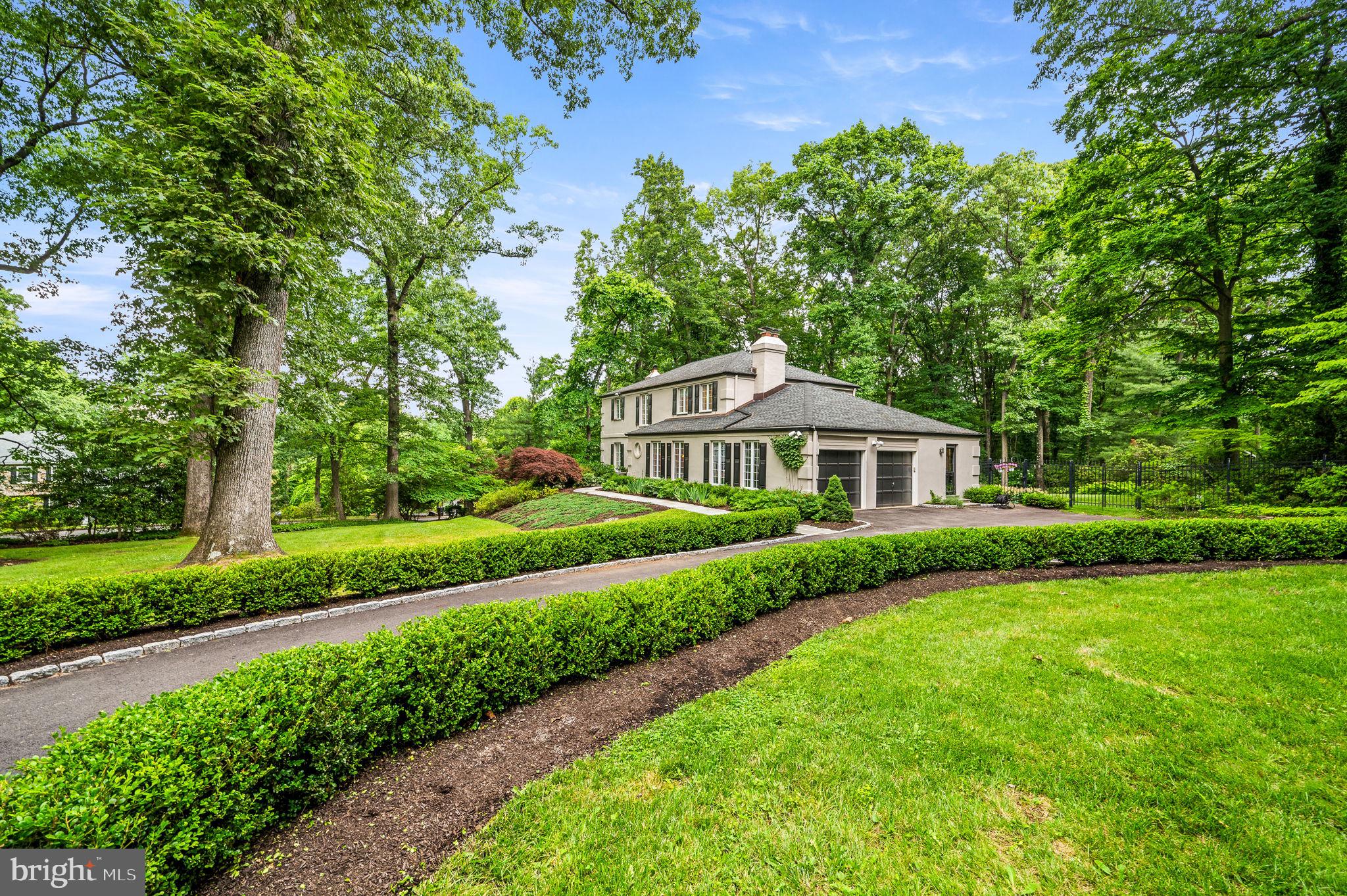 Showings begin Thursday, June 13. Stunning, impeccably-maintained residence nestled in a highly sought-after neighborhood, boasting a picturesque exterior and beautiful grounds. The elegant entrance welcomes you into a two-story foyer, exuding an air of sophistication. Natural light floods the interior through expansive windows, accentuating the beauty of the hardwood floors and intricate millwork. Entertain guests in the refined living room featuring panoramic views and a gas fireplace with slate surround and handsome mantel. The formal dining room, adorned with a brick accent wall and wood-burning fireplace, is perfect for hosting intimate gatherings. Alternatively, it can be repurposed as a versatile great room, as the previous owner did. The gourmet kitchen is a chef's dream, equipped with premium inset cabinetry, soapstone counters, and top-of-the-line Thermador appliances. A spacious pantry, open shelves, and hutch with glass doors provide further storage and interest. The delightful breakfast room enjoys a view of the gorgeous backyard and opens to an expansive Trex deck, perfect for al fresco dining. Enjoy your morning coffee or unwind at the end of the day as you take in the lush, backyard oasis, offering a spectacular show of blooming shrubs and perennials throughout the spring, summer, and fall, all protected by deer fence. Adjacent to the breakfast room is a cozy family room, with built-in bookcases, TV cabinet, and a beautiful view of the backyard. An updated powder room and large laundry/mud room with abundant storage complete the first floor. The hardwood floors continue on the stairs and throughout the 2nd floor, with hardwood under the bedroom carpets. Retreat to the serene primary suite with custom closets and a luxurious, renovated ensuite bath with double vanities. Two generously sized, bright guest bedrooms share a beautifully updated marble bath. The finished basement provides additional flexible living space, walk-in closets, and a walk-out to the backyard. A large unfinished area provides additional storage space. Added features include a whole-house generator and a deer fence to protect the spectacular yard. Conveniently located near major highways, shopping, and dining, this home offers the perfect blend of elegance and functionality. Don’t miss the opportunity to make it your own!