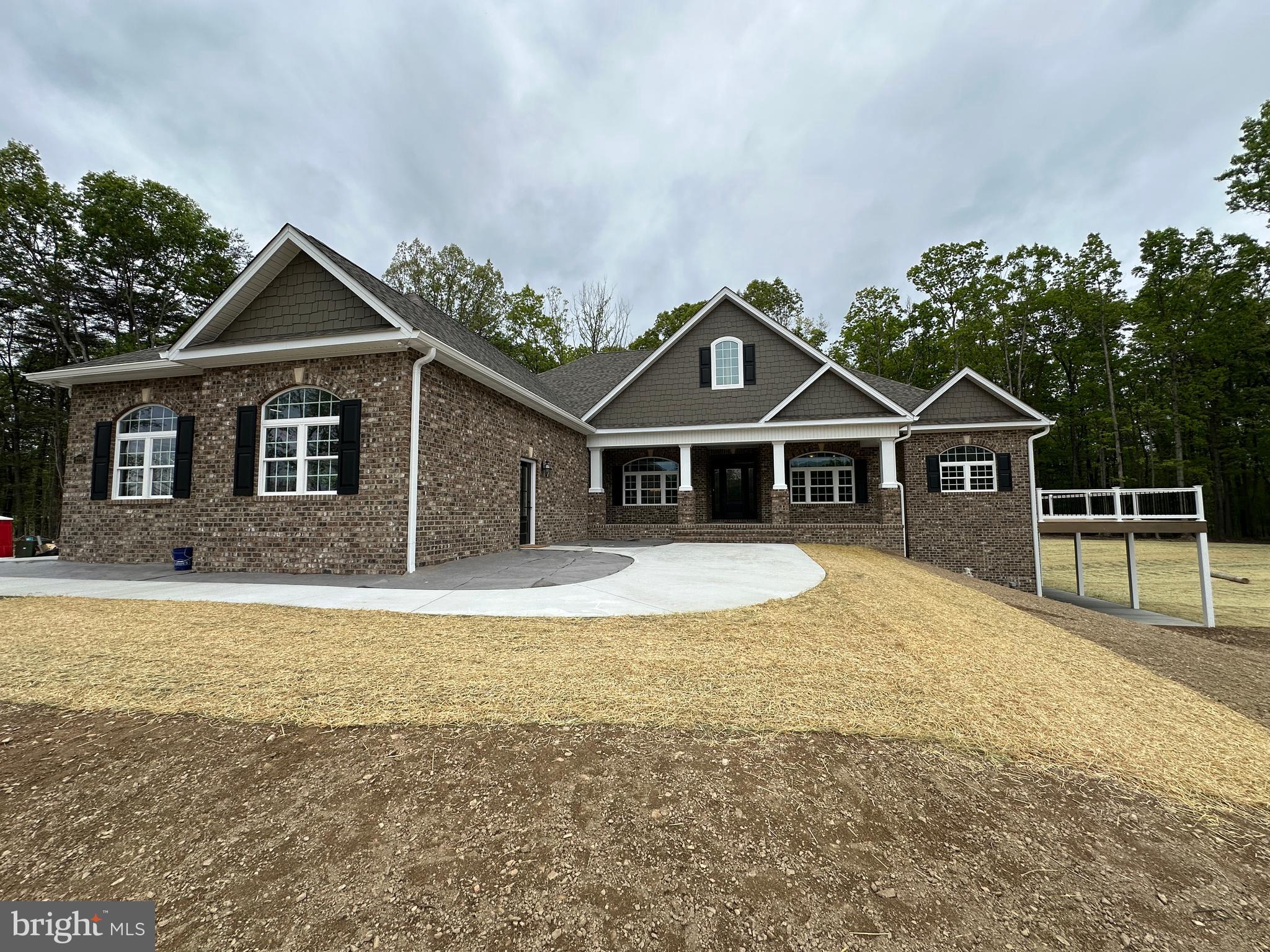 5-9-26 BEAUTY DONE/READY!  Pictures are of subject property.
Seize a truly unique opportunity to own a brand-new, luxury estate set on over 7 acres of private, wooded land. While this stunning property sits at the entrance to the prestigious, upper-scale 15-lot Keplinger Estates community, it does not have HOA, offering unparalleled freedom and privacy.
Tucked gracefully off the main road, this secluded retreat provides a peaceful, close-to-town setting without compromising on tranquility and space.
Experience the pinnacle of single-level living in this immaculate residence, meticulously designed with a flowing 3,100 sq. ft. open floor plan. The builder has redefined "standard features," integrating premium elements throughout the home that others typically label as costly upgrades.
Key Features & Elegant Finishes:
Striking Curb Appeal: A distinguished full brick front complemented by durable cement siding creates a timeless exterior, highlighted by a large, welcoming concrete front porch and lead walk.
Exquisite Main Level: Rich, stained Early American hardwood flooring flows seamlessly across the entire main level, excluding the elegant tiled bathrooms and laundry room, creating a warm, inviting atmosphere.
Expansive Indoor/Outdoor Living: The home is designed for seamless entertaining and relaxation, featuring an extensive covered and screened deck that connects to open deck that wraps around the entire right side of the house.  Full patio under covered and open decks.
Walk-Out Access & Patio: The basement boasts convenient double-door walk-out access, opening onto a full-length concrete patio that extends from the breakfast room and continues beneath the expansive side deck.
