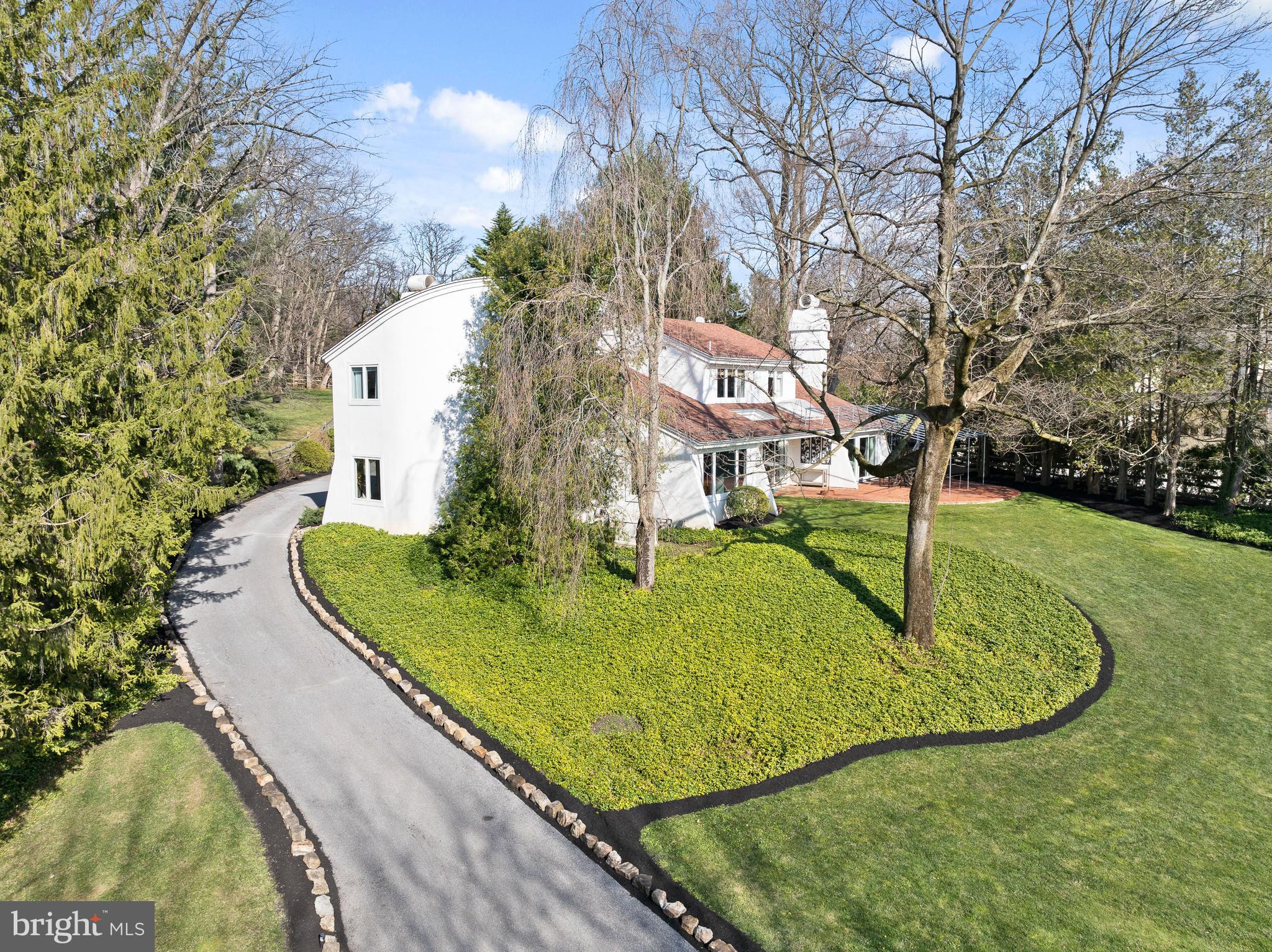 Indulge in the epitome of modern luxury living within this contemporary masterpiece, meticulously remodeled and professionally designed to evoke drama, elegance, and functionality. Situated on a serene double cul-de-sac neighborhood, this five-bedroom residence offers a unique three-dimensional living experience, seamlessly blending indoor and outdoor spaces. Bask in the tranquility of the landscaped grounds, featuring a swimming pool, terraces, and flower gardens, all visible through walls of sliding glass doors and large sunny windows.  Recently installed exterior lighting is automatically controlled by Lutron's Caseta System and designed to aesthetically and effortlessly guide you up the driveway and in full view of the stunning Japanese Maple that welcomes you home. Step through the grand foyer into the living room, where a fireplace, beamed ceiling, and dramatic curved wall create an intriguing and inviting ambiance. The adjacent dining room boasts abundant natural light and is perfect for hosting lively gatherings with family and friends. The eat-in kitchen is a chef's dream, showcasing double-glass cabinets, artisan hardware, and high-end appliances. The spacious family room, with its own fireplace and wall of glass, allows for maximum comfort and enjoyment while also seamlessly guiding you to the brick terrace and expansive yard beyond. The large, outdoor terrace adds yet another gathering space also wired for sound – al fresco cocktails, dining and grilling are the recipe for delicious fun & forever memories both inside and out!   
 
Discover a sumptuous first-floor bedroom suite with a limestone shower and private entry, ideal for guests or multi-generational living. Ascend the stunning cantilevered staircase to the luxurious primary bedroom suite, complete with a walk-in dressing room and spa-style bath. Three additional beautifully designed bedrooms and a full bath offer ample space for family or guests.  
 
The finished lower level provides additional living space, while recessed, dimmable lighting and a Generac generator add convenience and 24/7 peace of mind. The home features a premium geothermal HVAC system, purification enhancements to the home’s water and air handling systems throughout, LED lighting, and high-efficiency windows ensure both comfortable and sustainable living.
 
Centrally located in a very safe and sought-after neighborhood, this home offers easy access to award-winning schools, dining, shopping, commuter roads, and regional rail. With its ergonomic design and eco-conscious features, this modern home provides the perfect balance of sophistication and comfort, reminiscent of a Santa Barbara retreat.