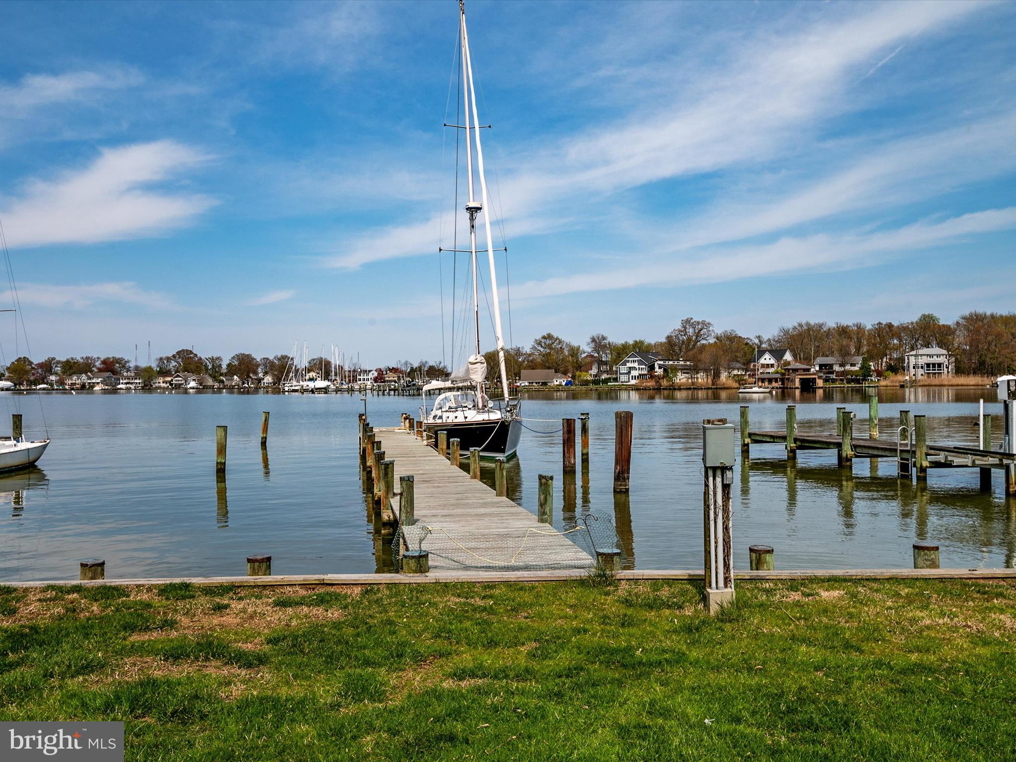 OPEN HOUSE CANCELLED - UNDER CONTRACT. Waterfront in the Bay Ridge community! Beautifully sited, light-filled home with well-maintained deep water pier, two boat slips, views across Lake Ogleton, and easy access to the Chesapeake Bay.  You will find yourself surrounded by nature in this peaceful oasis, with adjacent community-owned land enhancing the pastoral setting and providing added privacy.  Features of the home include an expansive waterside deck ideal for entertaining and watching wildlife,  open kitchen with stainless appliances, upper-level deck off the primary and secondary bedrooms, stone wood-burning fireplace, original hardwood floors throughout first floor, fresh interior paint, new bedroom carpeting, plenty of storage space, and a two-car garage. The first-floor office could be used as a 5th bedroom. This sought-after Annapolis waterfront community includes a 25 meter community pool with club house (available to Bay Ridge Pool Association members for a fee),  a marina with 120 boat slips, pickle ball and tennis courts, beaches, woods, and trails.  Neighborhood traditions include a 4th of July parade, Jamboree, and holiday party. This home has it all -  space for friends and family; deep water pier with two boat slips, water, and electric;  plenty of parking; the option for a main-floor bedroom; and desirable community amenities - less than 10 minutes by car from historic Annapolis and within commuting distance of DC and Baltimore.  See interactive tour and floor plan. NOTE: Bay Ridge (BRCA) is a Special Tax Assessment District w requested community membership dues of $300 per year.