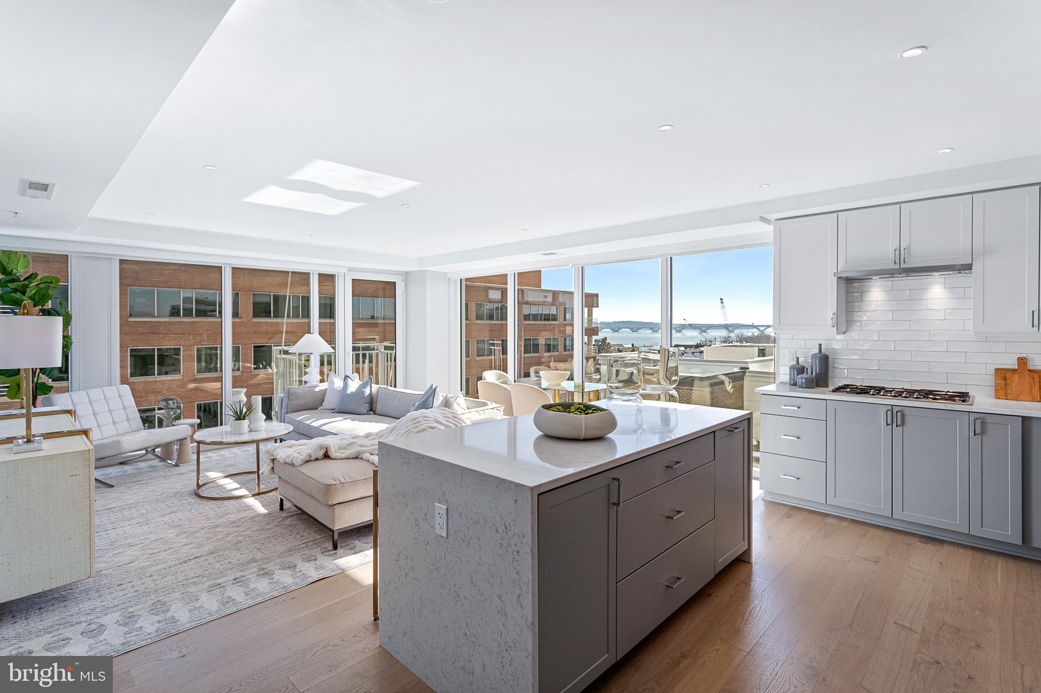 BRAND NEW THREE BED + DEN MODEL (CORNER UNIT) at Old Town's newest luxury condominium building, VENUE! Built by renowned local developer, Carr Companies, the finishes in this building are extraordinary. Chef's kitchens feature Bosch appliance packages, Quartz countertops, and custom cabinetry. This particular Three Bedroom + Den sits on the Southeast corner of the building offering 1800 sq ft of living space and views of The Potomac River from every room! FLOODED with natural sunlight and overlooking the Mt. Vernon trail, this residence also offers a view of The Capitol from its east-facing balcony! The owner's bedroom with en-suite bath features a double vanity and walk-in shower with a 5-point showerhead & detachable nozzle, Bianca Carrara walls & floors, and a custom built-in linen center. UPGRADES GALORE! Includes SEVEN custom built-in systems, recessed lighting throughout, brilliant control display, and wet walls in the bathrooms. A total of 7 closets allow for ample storage, including large walk-in closets in the owner's suite and third bedroom, a reach-in in the second bedroom, an extra large closet in the foyer, a pantry in the kitchen, and a linen closet in the powder room. VENUE offers a turn-key elevated lifestyle. Enter through the hotel-style Porte-Cochere into our Grand Lobby, where you will be met by our Full Service Concierge and on-site building manager to assist with your every need. The building features a sprawling Rooftop Terrace offering expansive panoramic views of the DC Monuments, Potomac River and Old Town skyline, as well as an outdoor grilling station and fire pit seating area. The elegant indoor Owner's Sky Lounge is equipped with flat-screen TV's, a fireplace, and a cocktail bar, perfect for entertaining! Relieve your stress in the State-of-the-art Fitness center complete with a Barre studio. VENUE is the ideal location in Old Town's most desirable neighborhood, right in the center of entertainment, restaurants, and shopping, with direct access to the Mount Vernon Trail. This is a MUST SEE THREE BEDROOM + DEN!! Immediate occupancy is available. Come see what all the fuss is about!