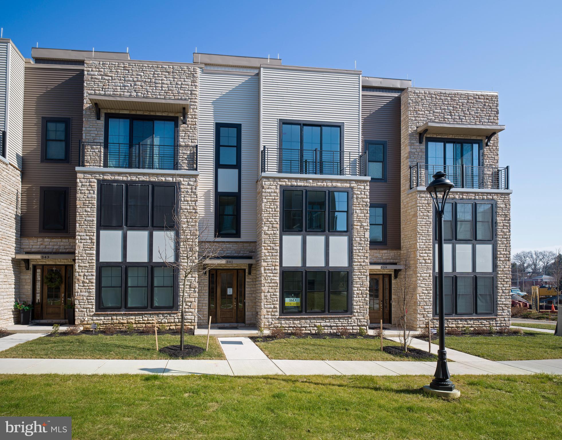 This is your chance to own in the now sold-out and highly sought-after community of The Towns at Newtown Walk—a collection of modern townhomes perfectly positioned within the vibrant Ellis Preserve. With walkability to brand-new shops, restaurants, and boutique fitness studios, this move-in ready home offers the best of low-maintenance luxury living.

Ideally situated with a charming pocket park directly in front, the home enjoys added greenery and a sense of privacy that enhances everyday living. Inside, a thoughtfully designed floor plan includes a 4-stop elevator, 2-car garage, and spacious driveway.

The entry level features 9-foot ceilings and a private bedroom with a full en-suite bathroom—perfect for guests or a dedicated home office. Throughout the home, you'll find upgraded options and designer finishes that elevate every space.

On the main living level, soaring 10-foot ceilings and large windows fill the home with natural light. The chef’s kitchen is a true showstopper, featuring upgraded quartz countertops, 42” soft-close cabinetry, premium stainless steel appliances, and an impressive 10-foot island—ideal for both everyday living and entertaining. The spacious dining area flows seamlessly into the inviting living room, complete with a gas fireplace flanked by custom built-ins—a perfect blend of warmth and function.

The upper level includes a serene primary suite with a large walk-in closet and a spa-inspired bath with double vanity and walk-in shower, a second en-suite bedroom, a laundry area, and generous storage space.

The rooftop terrace offers a private outdoor retreat with endless potential—perfect for morning coffee, sunset dinners, or creating your dream outdoor lounge.

All of this within walking distance to Whole Foods, cafés, and local eateries—and just minutes to major roadways, the airport, and public transit.

Don’t miss this rare opportunity to own in one of Newtown Square’s most desirable communities.  Some images have been virtually staged.