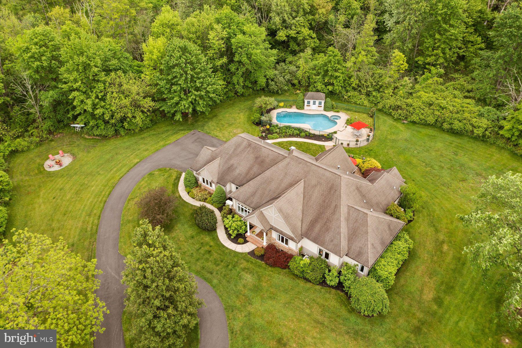 Experience the perfect blend of luxury and tranquility in this spacious one-story home, beautifully situated on a secluded property near Lake Nockamixon. Designed with integrated handicap-accessible features, this home boasts high ceilings and custom sustainable Tigerwood floors throughout, ensuring both elegance and ease of movement.
The heart of the home is the Great Room, featuring a gracious kitchen with custom banquette seating, ideal for casual family meals or entertaining guests. The main bedroom suite is a true retreat, offering French doors that open to the serene garden, an ample walk-in closet, and an additional office/additional walk-in closet for extra convenience.
The lower level is designed for entertainment and relaxation, with a fun game room and a comfortable surround sound family room perfect for watching any sports game. An oversized 3-car garage with a high garage door and built-in ramp provides plenty of space and easy access.
Outdoors, the property features a stunning  pool set on 5.26 acres of land, offering numerous options for gardens, farming, or simply enjoying the peaceful surroundings. The location is ideal for outdoor enthusiasts, with a short walk leading to Lake Nockamixon's walking, horse, and bike trails. The lake provides 6 miles of coves and open water for fishing, kayaking, birdwatching, and sailing.
Conveniently located, this home is just 22 minutes from both Doylestown and Bethlehem, 60 minutes from Philadelphia, and 90 minutes from New York City. Enjoy the best of both worlds with easy access to urban amenities while savoring the tranquility of rural living. Don't miss the opportunity to make this exceptional property your new home.