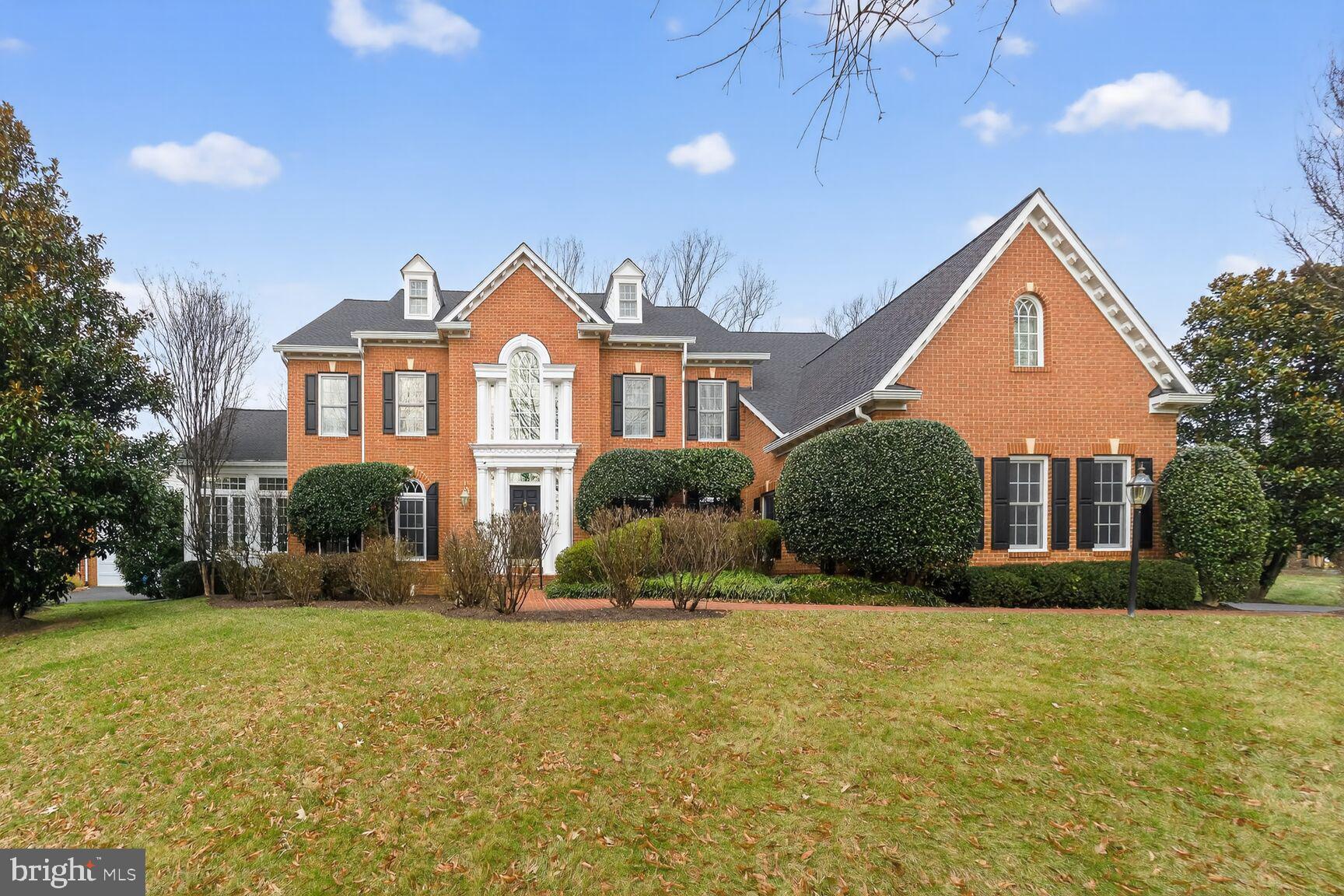 Welcome home to this 5 bedroom, 5.5 bath colonial with 3-car attached garage in the tight- knit community of Cedar Chase! Perched on a gracious corner lot, this brick-front marvel is a testament to spacious living woven with intimate charm, creating an idyllic setting for daily life and entertaining. A grand two-story foyer, bathed in natural light, unfolds into a thoughtfully designed floor plan. To the left, a formal living room is followed by a light-filled sunroom. To the right, a formal dining room is followed by a great room with cathedral ceilings and gas fireplace. Step from the great room to a home office space with double door entry offering a peaceful retreat for work or study. Enjoy a gorgeous open kitchen with granite counters and stainless steel appliances, all opening to a large sitting room and breakfast room. Glass doors lead from the kitchen to a rear brick patio with built-in fireplace. From the kitchen, an adjoining mudroom leads to a spacious laundry room and access to the attached 3-car garage. Upstairs find a primary suite with sitting room, fireplace, two walk-in closets and a luxurious bath while three more bedrooms down the hall all have their own en suite baths. The lower level features a spacious rec room with wet bar, a game room, a TV room with rear walk-out, a guest bedroom with full bathroom, a flexible workout space, and two spacious storage rooms. All this with easy access to Route 7 and Georgetown Pike and just moments to Reston Town Center, Tysons and Great Falls Village Center!
