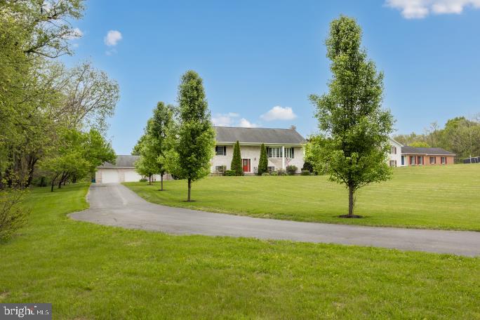 No HOA. Set on more than an acre with beautiful views and mature landscaping, this exceptional all-brick property offers the ideal combination of comfortable living, dedicated work-from-home functionality, and incredible space for hobbies, projects, and recreation. This property was designed to support the way you live and work.

A long private driveway leads to an expansive parking area with room for multiple vehicles, trailers, boats, or work equipment, along with convenient turnaround space that adds both practicality and privacy. The detached all-brick workshop building is a standout feature, offering two garage bays —perfect for woodworking, automotive projects, crafting, inventory storage, or studio separate from the main home.  A well-lit, floored attic, ideal for storage completes this versatile space.

Inside, the upper level features stunning new hardwood floors, an oversized living room filled with natural light, and a thoughtfully designed kitchen complete with stainless steel appliances and abundant cabinetry. With 3 spacious bedrooms and 3 full bathrooms, this home provides flexibility and comfort.

The lower level is designed for entertaining and relaxation, featuring a cozy gas fireplace, pool table area, wet bar, and an additional living space ideal for gatherings or game nights. New sliding doors open seamlessly to the outdoor living areas, including a patio, composite deck, and fenced backyard perfect for entertaining, pets, or enjoying the peaceful surroundings.

The oversized attached two-car garage is large enough to comfortably accommodate full-size trucks or SUVs while still providing room for tools, equipment, and storage. Every aspect of this property reflects a lifestyle centered around comfort, productivity, recreation, and privacy.

Combining timeless brick construction, generous living spaces, mature landscaping, and a versatile outbuilding, this unique property is perfectly suited for those who want more than just a house. 

Located in Boonsboro a short drive to Interstate Routes 70 and 81.  
There is no sign on the property.  Located at Breathedsville and Lappans Rds.