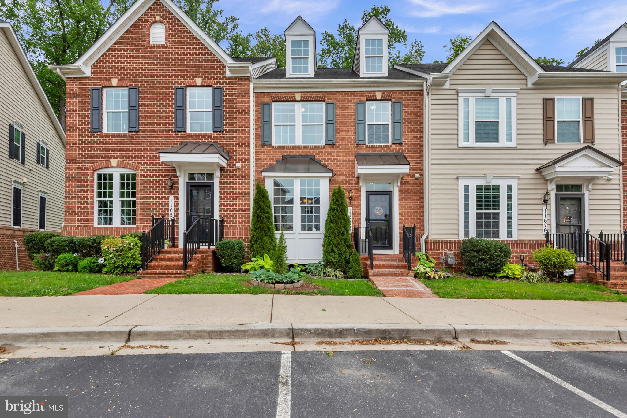 Beautifully updated brick-front townhome in sought-after Clarksburg Village offering three finished levels and an ideal setting backing to woods and fronting open green space. This light-filled home features wide plank hardwood floors, a spacious bay window, stainless steel appliances, custom Azek deck with grill bump-out, walkout lower level, custom closets, tray ceiling in the primary suite, upgraded washer and dryer, wet bar rough-in in the lower level, and so much more. A rare combination of upgrades, space, and location — this one is not to be missed!