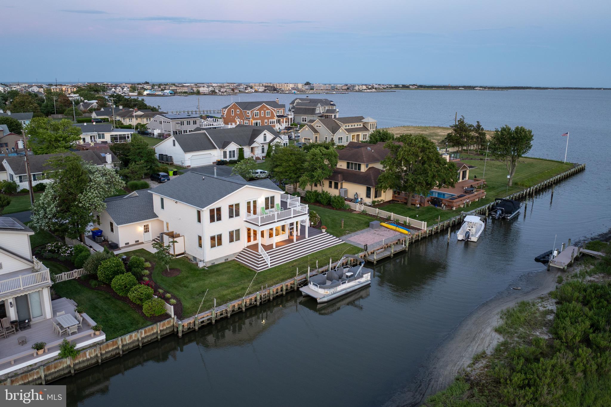 RARE WATERFRONT OPPORTUNITY IN REHOBOTH BEACH WITH PRIVATE DOCK, BAY ACCESS & WALK TO THE OCEAN! Discover one of the Delaware Beaches' most unique waterfront offerings, combining an extraordinary location with an exceptional coastal lifestyle. Perfectly positioned in the quiet Seabreeze community, this spacious waterfront residence is just five blocks from the Atlantic Ocean, a short walk to the heart of Dewey Beach, and offers direct boating access to Rehoboth Bay from your private dock—a rare combination found in only a handful of area properties. Set along a protected marsh with panoramic water, wildlife, and sunset views, this approximately 3,500-square-foot home is designed for both everyday living and entertaining. The flexible floor plan features expansive gathering spaces, including a large living room with fireplace and wet bar, an oversized family/game room overlooking the bay, and a generously sized kitchen with custom Graybill cabinetry, center island, abundant storage, and multiple dining areas. Offering up to six potential bedrooms, four full baths, and a first-floor primary suite with an accessible ensuite bath, the home easily accommodates family and guests. Multiple decks, a three-season sunroom, and seamless indoor-outdoor living maximize the spectacular western-facing sunsets and ever-changing marsh views. Outside, more than 100 feet of bulkhead and a private dock make it easy to keep multiple boats at your doorstep while providing quick access to Rehoboth Bay, the Rehoboth-Lewes Canal, Massey's Ditch, Indian River Inlet, waterfront restaurants, fishing, crabbing, clamming, kayaking, and paddleboarding—all directly from your backyard. Recent improvements include a new roof (2024), encapsulated crawlspace with concrete floor in the newer section, HardiePlank siding, oversized composite decking, and numerous accessibility features including step-free first-floor access. Whether you're searching for a primary residence, luxury beach retreat, or waterfront family compound, this remarkable home offers an unmatched combination of boating, beach access, walkability, breathtaking sunsets, and the relaxed coastal lifestyle that defines Rehoboth Beach.