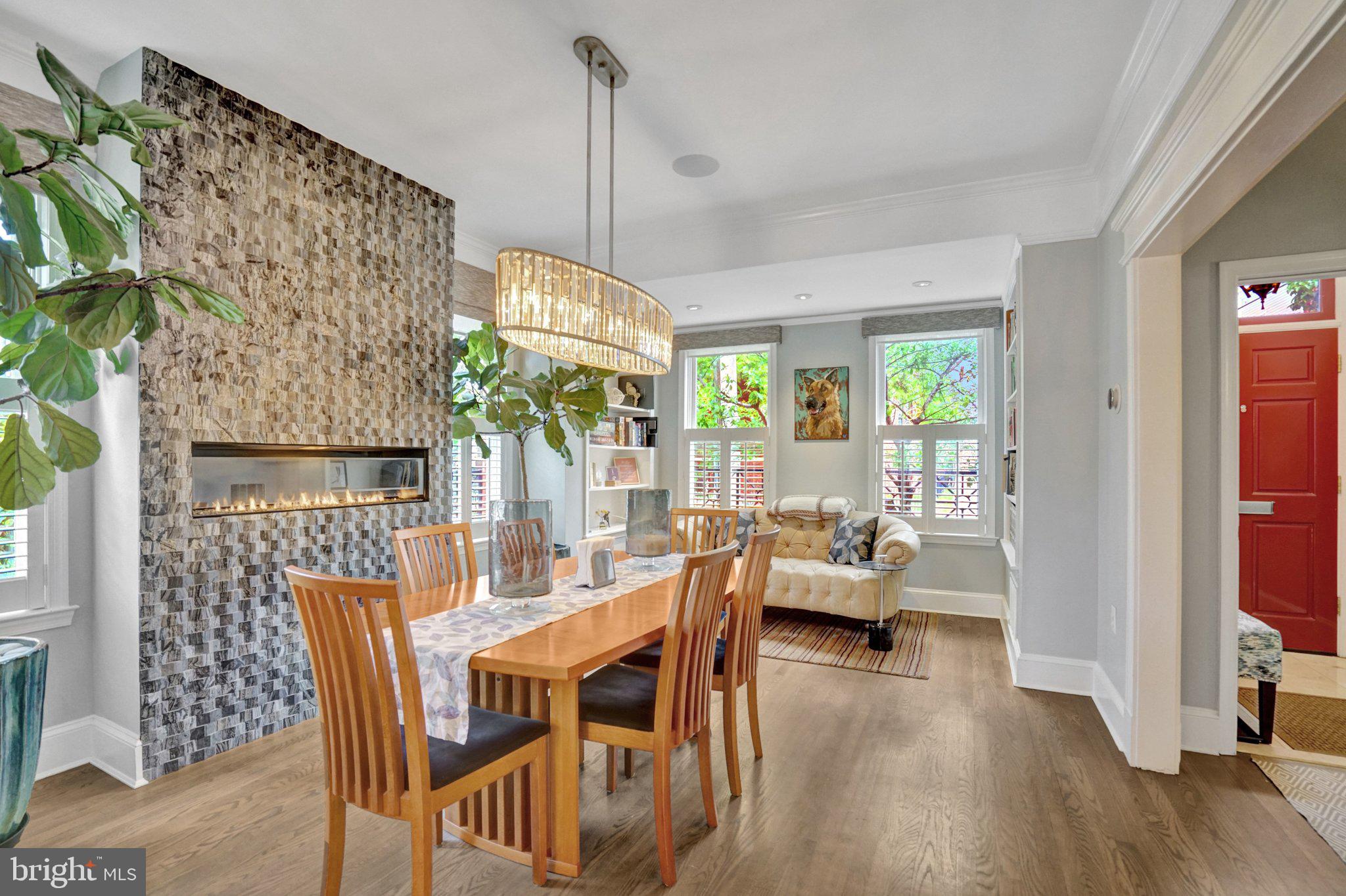 Tastefully remodeled and exceptionally upgraded, this stunning 5-bedroom, 4.5-bathroom townhome in highly sought-after Old Town Alexandria offers over 3,900 square feet of living space.

The main level features a bright, open floor plan with hardwood flooring, custom dimmable lighting, built-in shelving, and Sonos in-ceiling speakers. The remote-controlled gas fireplace features a custom floor-to-ceiling stone surround and smart temperature control. The remodeled kitchen is equipped with Viking appliances, new custom cabinetry, a 14’ x 4’ quartz island countertop, and a wine refrigerator. A conveniently located half bath sits on the stairway.

The entire second level is a self-contained primary suite. Highlights include hardwood flooring, custom lighting, Sonos in-ceiling speakers in both the bedroom and bathroom, and a remote-controlled electric fireplace with customizable color and temperature settings. The oversized walk-in closet leads to the remodeled primary bathroom, featuring premium tile, heated floors, dual vanities, a standing shower with dual shower heads, and a custom soaking tub. A laundry room is also located on this level for added convenience.

The third level offers three additional bedrooms with hardwood flooring, two of which include en-suite bathrooms.

Enjoy breathtaking panoramic views from the rooftop deck, complete with composite decking and railing, a water spigot, and electrical outlets. Take in unobstructed sunsets and direct views of Oronoco Bay—perfect for watching Alexandria’s annual fireworks.

The lower level is ideal for an in-law suite or rental opportunity, featuring new luxury vinyl flooring, a sound-dampening ceiling, a private bedroom, a full bathroom, a kitchenette, and a private entrance with a doggy door providing easy access to the backyard.

The fully fenced-in backyard is thoughtfully designed with a composite deck, remote-controlled electric awning with LED lighting, and professionally installed landscaping both inside and outside the fence.  A custom Corten Steel planter with a water feature enhances the space, while providing a clear path for dogs to run around without damaging plants. The Rain Bird Irrigation System and SMRTscape Landscape Lighting can both be controlled via smartphone apps. A custom fence gap was created for dogs to look out, also providing convenient package delivery. Landscaping highlights include European hornbeams, weeping Japanese snowbells, weeping Colorado blue spruce, Flamethrower redbud, southern magnolia, fig tree, strawberry plants, and 3-season perennials.

Additional features include: Two-zone HVAC systems with regular professional maintenance, an air scrubber, and a dynamic electronic air filter. New gas package system (Sept 2025). New heat pump system (May 2021).  Google Nest Pro Thermostats. New sump pump (May 2025). Commercial-grade 50-gallon electric water heater with expansion tank and auto shut-off (April 2020).

The property includes two dedicated and off-street parking spaces adjacent to the home, with additional owned space between the fence and the parking area.

Ability for elevator installation!

This exceptional home seamlessly blends luxury, functionality, and modern convenience in one of Alexandria’s most desirable locations. The current owners have put a lot of time and money into renovating/upgrading this property. In addition to the cosmetic transformations shown in the photos, the roof, water heater, and all of the HVAC systems have been replaced and upgraded. You will not find a more thoughtfully remodeled and meticulously cared-for home on the market. Don’t miss this rare opportunity! NO HOA!!! And for devotees of Trader Joe's, this home is literally across the street.