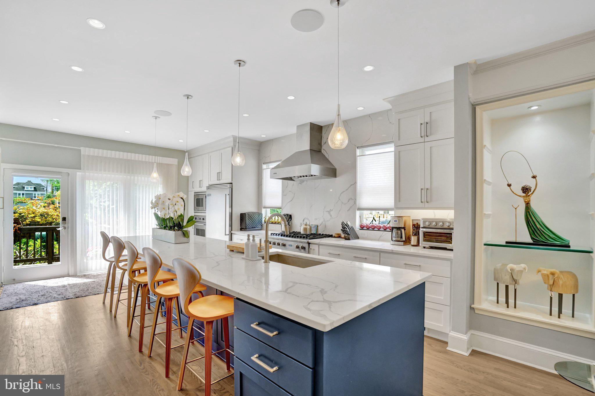 Tastefully remodeled and exceptionally upgraded, this stunning 5-bedroom, 4.5-bathroom townhome in highly sought-after Old Town Alexandria offers over 3,900 square feet of living space.

The main level features a bright, open floor plan with hardwood flooring, custom dimmable lighting, built-in shelving, and Sonos in-ceiling speakers. The remote-controlled gas fireplace features a custom floor-to-ceiling stone surround and smart temperature control. The remodeled kitchen is equipped with Viking appliances, new custom cabinetry, a 14’ x 4’ quartz island countertop, and a wine refrigerator. A conveniently located half bath sits on the stairway.

The entire second level is a self-contained primary suite. Highlights include hardwood flooring, custom lighting, Sonos in-ceiling speakers in both the bedroom and bathroom, and a remote-controlled electric fireplace with customizable color and temperature settings. The oversized walk-in closet leads to the remodeled primary bathroom, featuring premium tile, heated floors, dual vanities, a standing shower with dual shower heads, and a custom soaking tub. A laundry room is also located on this level for added convenience.

The third level offers three additional bedrooms with hardwood flooring, two of which include en-suite bathrooms.

Enjoy breathtaking panoramic views from the rooftop deck, complete with composite decking and railing, a water spigot, and electrical outlets. Take in unobstructed sunsets and direct views of Oronoco Bay—perfect for watching Alexandria’s annual fireworks.

The lower level is ideal for an in-law suite or rental opportunity, featuring new luxury vinyl flooring, a sound-dampening ceiling, a private bedroom, a full bathroom, a kitchenette, and a private entrance with a doggy door providing easy access to the backyard.

The fully fenced-in backyard is thoughtfully designed with a composite deck, remote-controlled electric awning with LED lighting, and professionally installed landscaping both inside and outside the fence.  A custom Corten Steel planter with a water feature enhances the space, while providing a clear path for dogs to run around without damaging plants. The Rain Bird Irrigation System and SMRTscape Landscape Lighting can both be controlled via smartphone apps. A custom fence gap was created for dogs to look out, also providing convenient package delivery. Landscaping highlights include European hornbeams, weeping Japanese snowbells, weeping Colorado blue spruce, Flamethrower redbud, southern magnolia, fig tree, strawberry plants, and 3-season perennials.

Additional features include: Two-zone HVAC systems with regular professional maintenance, an air scrubber, and a dynamic electronic air filter. New gas package system (Sept 2025). New heat pump system (May 2021).  Google Nest Pro Thermostats. New sump pump (May 2025). Commercial-grade 50-gallon electric water heater with expansion tank and auto shut-off (April 2020).

The property includes two dedicated and off-street parking spaces adjacent to the home, with additional owned space between the fence and the parking area.

Ability for elevator installation!

This exceptional home seamlessly blends luxury, functionality, and modern convenience in one of Alexandria’s most desirable locations. The current owners have put a lot of time and money into renovating/upgrading this property. In addition to the cosmetic transformations shown in the photos, the roof, water heater, and all of the HVAC systems have been replaced and upgraded. You will not find a more thoughtfully remodeled and meticulously cared-for home on the market. Don’t miss this rare opportunity! NO HOA!!! And for devotees of Trader Joe's, this home is literally across the street.