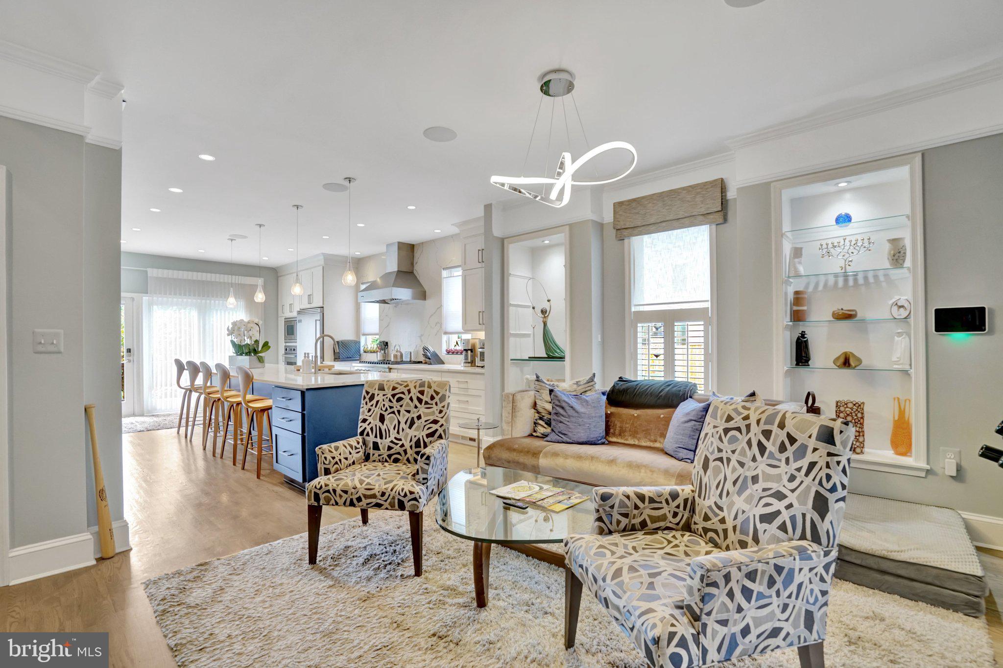 Tastefully remodeled and exceptionally upgraded, this stunning 5-bedroom, 4.5-bathroom townhome in highly sought-after Old Town Alexandria offers over 3,900 square feet of living space.

The main level features a bright, open floor plan with hardwood flooring, custom dimmable lighting, built-in shelving, and Sonos in-ceiling speakers. The remote-controlled gas fireplace features a custom floor-to-ceiling stone surround and smart temperature control. The remodeled kitchen is equipped with Viking appliances, new custom cabinetry, a 14’ x 4’ quartz island countertop, and a wine refrigerator. A conveniently located half bath sits on the stairway.

The entire second level is a self-contained primary suite. Highlights include hardwood flooring, custom lighting, Sonos in-ceiling speakers in both the bedroom and bathroom, and a remote-controlled electric fireplace with customizable color and temperature settings. The oversized walk-in closet leads to the remodeled primary bathroom, featuring premium tile, heated floors, dual vanities, a standing shower with dual shower heads, and a custom soaking tub. A laundry room is also located on this level for added convenience.

The third level offers three additional bedrooms with hardwood flooring, two of which include en-suite bathrooms.

Enjoy breathtaking panoramic views from the rooftop deck, complete with composite decking and railing, a water spigot, and electrical outlets. Take in unobstructed sunsets and direct views of Oronoco Bay—perfect for watching Alexandria’s annual fireworks.

The lower level is ideal for an in-law suite or rental opportunity, featuring new luxury vinyl flooring, a sound-dampening ceiling, a private bedroom, a full bathroom, a kitchenette, and a private entrance with a doggy door providing easy access to the backyard.

The fully fenced-in backyard is thoughtfully designed with a composite deck, remote-controlled electric awning with LED lighting, and professionally installed landscaping. A custom Corten Steel planter with water feature enhances the space, while providing a clear path for dogs to run around without damaging plants. The Rain Bird Irrigation System and SMRTscape Landscape Lighting can both be controlled via smartphone apps. A custom fence gap was created for dogs to look out, also providing convenient package delivery. Landscaping highlights include European hornbeams, weeping Japanese snowbells, weeping Colorado blue spruce, Flamethrower redbud, southern magnolia, fig tree, strawberry plants, and 3-season perennials.

Additional features include: Two-zone HVAC systems with regular professional maintenance. New gas package system (Sept 2025). New heat pump system (May 2021). Air scrubber and dynamic electronic air filter. Google Nest Pro Thermostats. New sump pump (May 2025). Commercial-grade 50-gallon electric water heater with expansion tank and auto shut-off (April 2020).

The property includes two dedicated and off-street parking spaces adjacent to the home, with additional owned space between the fence and the parking area.

Ability for elevator installation!

This exceptional home seamlessly blends luxury, functionality, and modern convenience in one of Alexandria’s most desirable locations. Don’t miss this rare opportunity! NO HOA!!! And for devotees of Trader Joe's, this home is literally across the street.