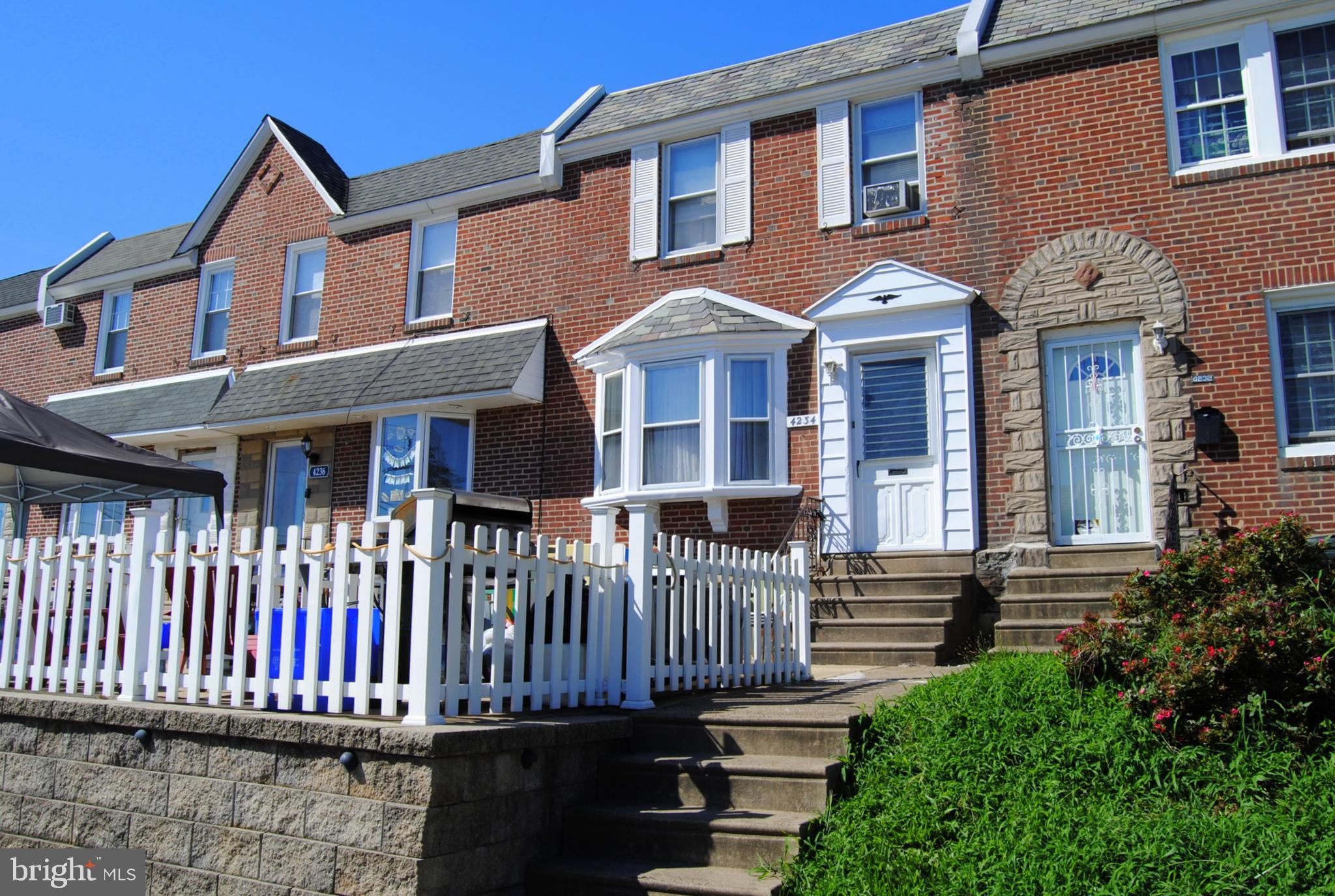 Two way street in Mayfair , Beautiful retaining wall , PVC fenced patio . Formal living room with hardwood floors ,Coat closet ,  bay window , formal dining room with hardwood floors,  ceiling fan . Kitchen with stool seating , gas range , range hood , vinyl floor . Finished basement , laminate hw flooring , recessed lights ,garage converted to bedroom with carpets , recessed lights , full bath with stall shower in basement . Laundry closet in hall . Exit to rear driveway . Gas hot water heater , gas hot water radios heat . 2nd Fl has rear bedroom with hw floors , ceiling fan light , middle bedroom with hardwood floors , ceiling fan light , closet . 3 pc Hall bath With skylight , tiled walls , vinyl floor . Main bedroom with hardwood floors , ceiling fan , 2 closets and armoire area . Fresh paint through out . Great block , close and convenient to stores on Frankford ave - public transportation, shopping . 15-20 mins to NJ and center city . ** NEW ROOF **