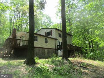 If you are looking for seclusion and to be in the woods this is your home. Located on Bear Mountain you will see plenty of nature. Living room and loft have knotty pine wood and vaulted ceilings, kitchen, family room and dining room are open with LVP flooring. Bedrooms are on main level along with laundry. 
*The 3rd bedroom is currently a laundry room/storage area. The owner can change back to original laundry room location if desired. Make your appointment today!