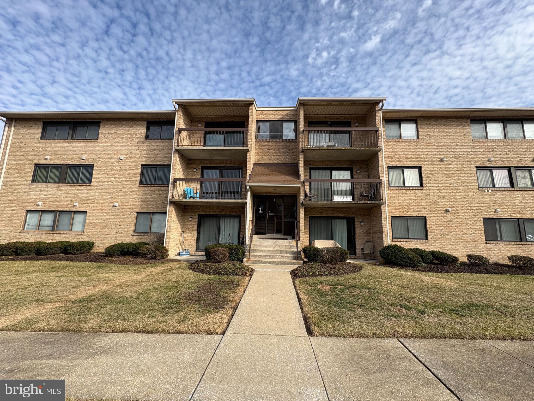 Welcome home to your ground floor unit with a walk out to your private balcony. Newer windows and patio door, water heater. with  extra storage just feet away from your door. The association covers lawn care, snow removal, trash and water. Plenty of parking and located just off 695 and commuter routes.
