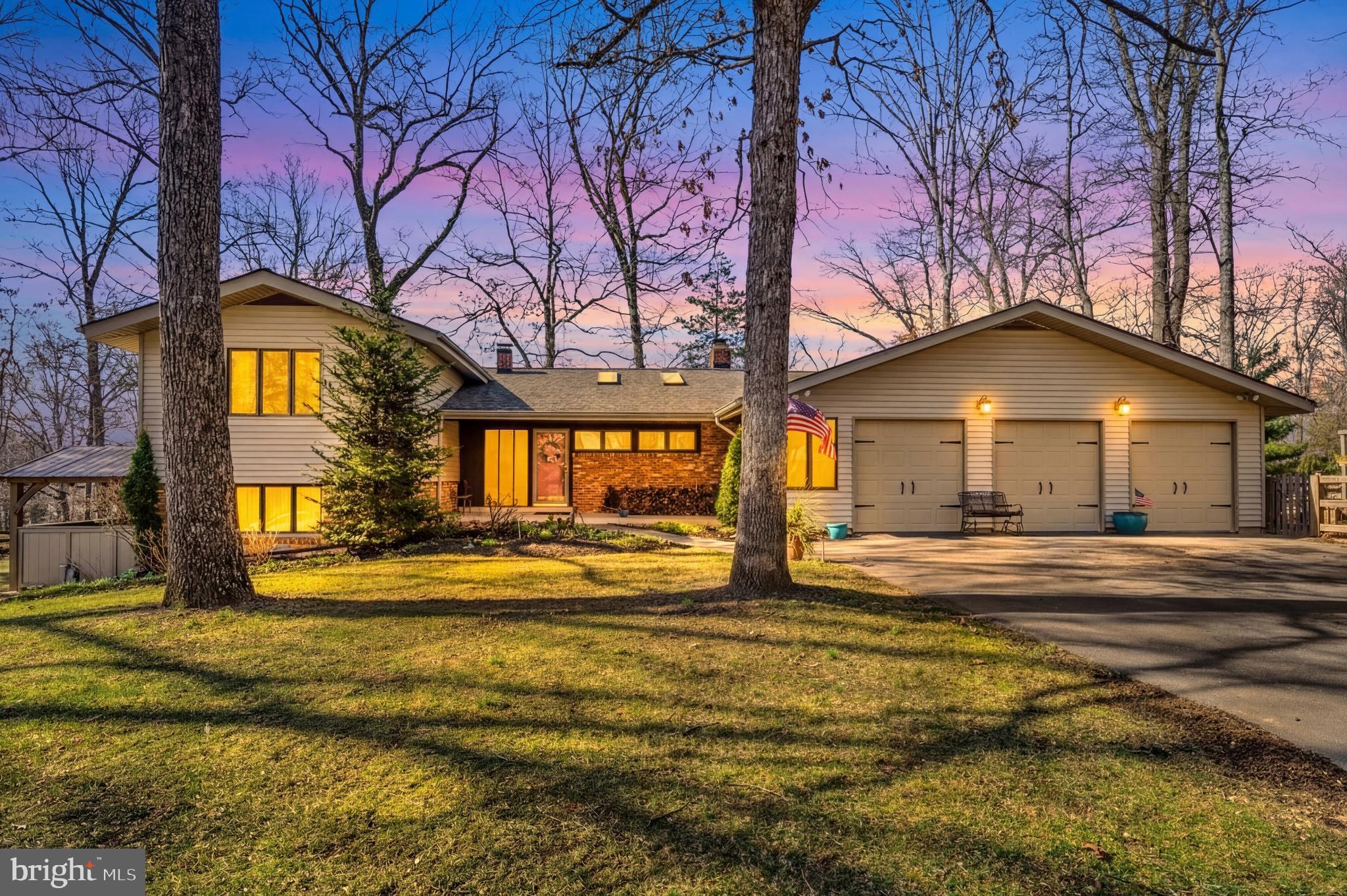 Experience the best of Granby Woods in this expansive 3,400+ square foot retreat, perfectly situated on a lush 3/4-acre cul-de-sac lot. This four-level home balances grand entertaining spaces with private sanctuaries, starting with a sun-drenched gourmet kitchen featuring 9-foot ceilings, stainless appliances, and a massive 5’x 8’ center island. The open living area impresses with vaulted ceilings and a wood-burning fireplace, flowing seamlessly toward an elevated 400-square-foot deck and a charming screened-in porch.

The layout is designed for ultimate privacy, highlighted by a dedicated level for the primary suite that features a spa bath, exercise room, and a secluded porch with a private hot tub. Three additional bedrooms with double closets provide ample space for family or guests, while the lower-level game room—complete with a pool table and surround sound—serves as the home’s entertainment hub. Outside, slate paths lead to a functional three-car garage and workshop, all surrounded by professionally landscaped gardens that bloom year-round.