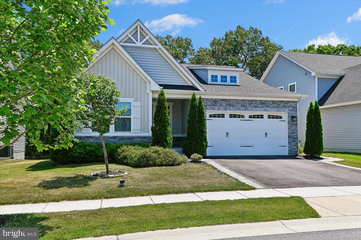 Discover a luxurious lifestyle in this exquisite Craftsman-style home nestled in the desirable Shipley Homestead community. Built in 2018, this residence boasts an open floor plan that seamlessly connects the gourmet kitchen, featuring upgraded countertops and stainless steel appliances, to the inviting family room. Enjoy the convenience of a main-floor laundry and a spacious primary suite with a lavish bath, complete with a walk-in shower. Step outside to your private oasis, where a charming porch and expansive deck await, perfect for entertaining or relaxing in the serene rear yard. The community offers exceptional amenities, including a refreshing outdoor pool, fitness center, and clubhouse, enhancing your everyday living experience. With a fully finished basement, two-car garage, and energy-efficient features throughout, this home is designed for comfort and elegance. Embrace the perfect blend of luxury and community in this stunning property, where every detail invites you to create lasting memories.
