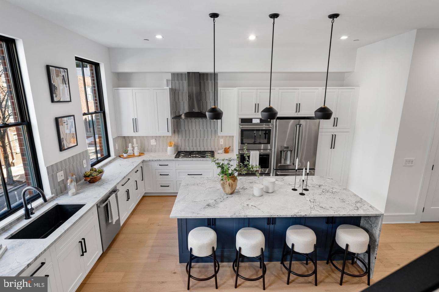 This collection of 4-story luxury townhomes in Old City—delivering Spring 2026—offers 2-car attached garage parking, a gated drive aisle, 10+ foot ceilings, private outdoor spaces, and stunning skyline and bridge views from expansive roof decks. Set in the historic heart of Old City Philadelphia, the homes feature timeless brick facades that complement the surrounding colonial architecture. Enter through a light-filled foyer with oversized Pella windows and striking black frames. The main level showcases a designer kitchen with Café stainless steel appliances, Bosch dishwasher, quartzite countertops, custom tile backsplash, and high-end cabinetry. The open layout continues through the dining area into a spacious living room with sliding doors leading to a private balcony. The second floor includes two generously sized bedrooms, two full bathrooms, and a convenient laundry area with washer and dryer. The entire third floor is dedicated to a luxurious primary suite featuring abundant natural light, walk-in closets, and a spa-like bathroom with heated tile floors, a freestanding soaking tub, and a large glass-enclosed shower with body sprays. Above, the pilot house leads to a roof deck with incredible views of Old City, the Benjamin Franklin Bridge, and the Philadelphia skyline. The finished basement, complete with a full bathroom and 10’ ceilings, offers flexible space for a home office, guest suite, or playroom. Additional features include multi-zone HVAC, smart home technology (Ring doorbell, Nest thermostats, and Schlage keyless entry), and thoughtful design throughout. Enjoy close proximity to the waterfront, local dining, shopping, and easy access to I-95, all within the McCall Elementary School catchment. Each home includes a 10-year real estate tax abatement and a 1-year builder warranty. ***Taxes and square footage to be independently verified. Photos are of a model unit; floor plans and finishes may be different***