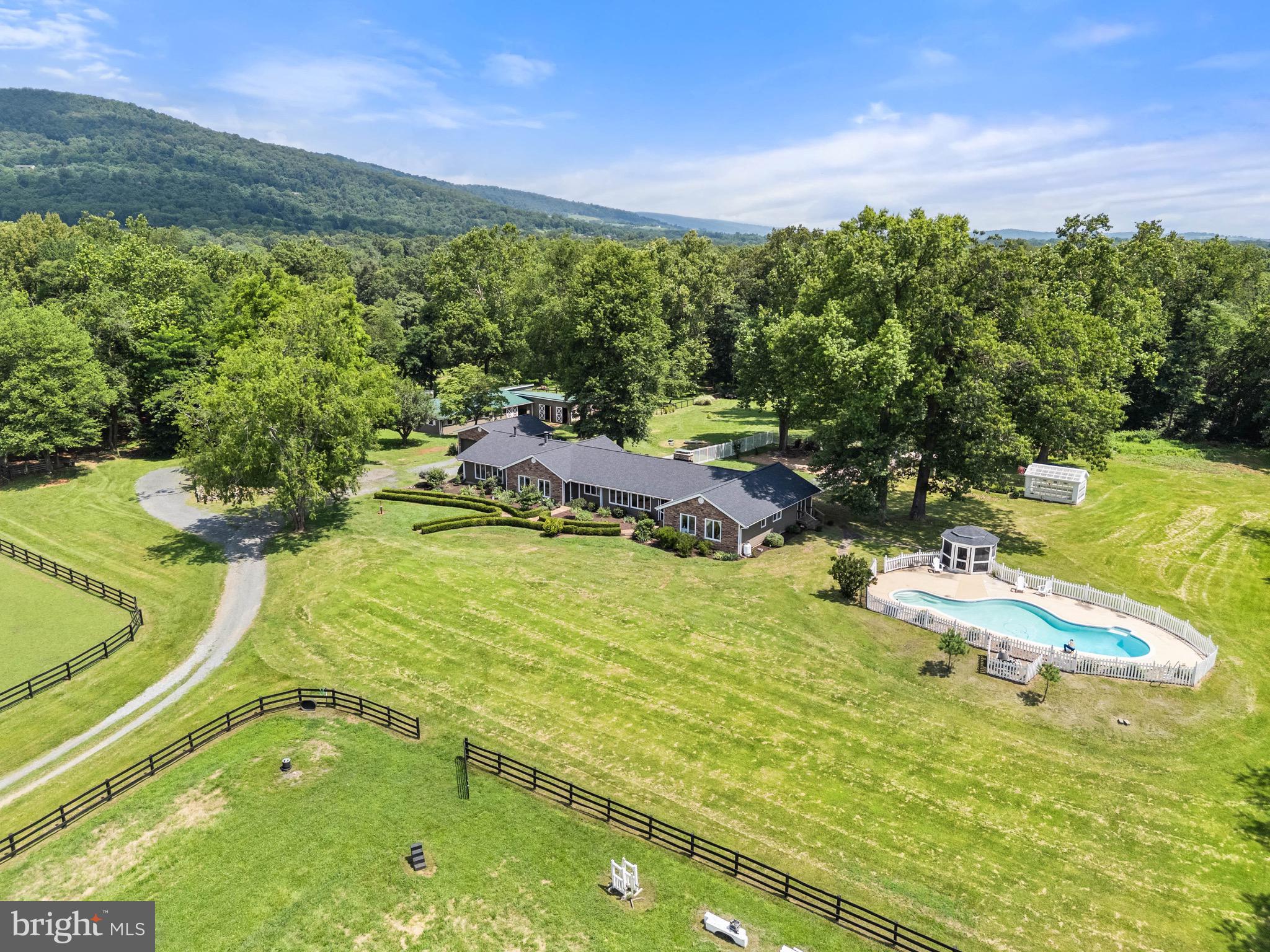 Beautifully updated three bedroom, two and a half bath ranch style home with a separate in-law suite/apartment sits on two separate parcels totaling over 43 acres.  The farm includes the main house, barn and pool on 20 acres (tax parcel 653160744) and an adjoining 23-acre parcel (Tax parcel 653158587) with two building envelopes. Renovations in 2020 included a new kitchen and bathrooms, hardi-plank siding, oak hardwood flooring and upgraded lighting throughout. The homes open -plan living room features a fireplace with views of fields and the Blue Ridge mountains. A wall of bifold doors in the kitchen open onto a spacious deck, perfect for indoor/outdoor entertaining. Mature trees and professional landscaping surround the home and the pool and the gazebo The roof and the septic system were replaced in 2023. The apartment has a separately zoned mini split system and a wood burning stove. Other property features include a two-car garage, greenhouse, ten stall horse barn, matted, tack room and feed room. Dog kennels with runs and an attached machine shed. The property is in conservation easement and is situated within an area of similar conservation parcels. Great hunt country location convenient to Dulles airport and the Washington DC metropolitan area. More Pictures will be uploaded.