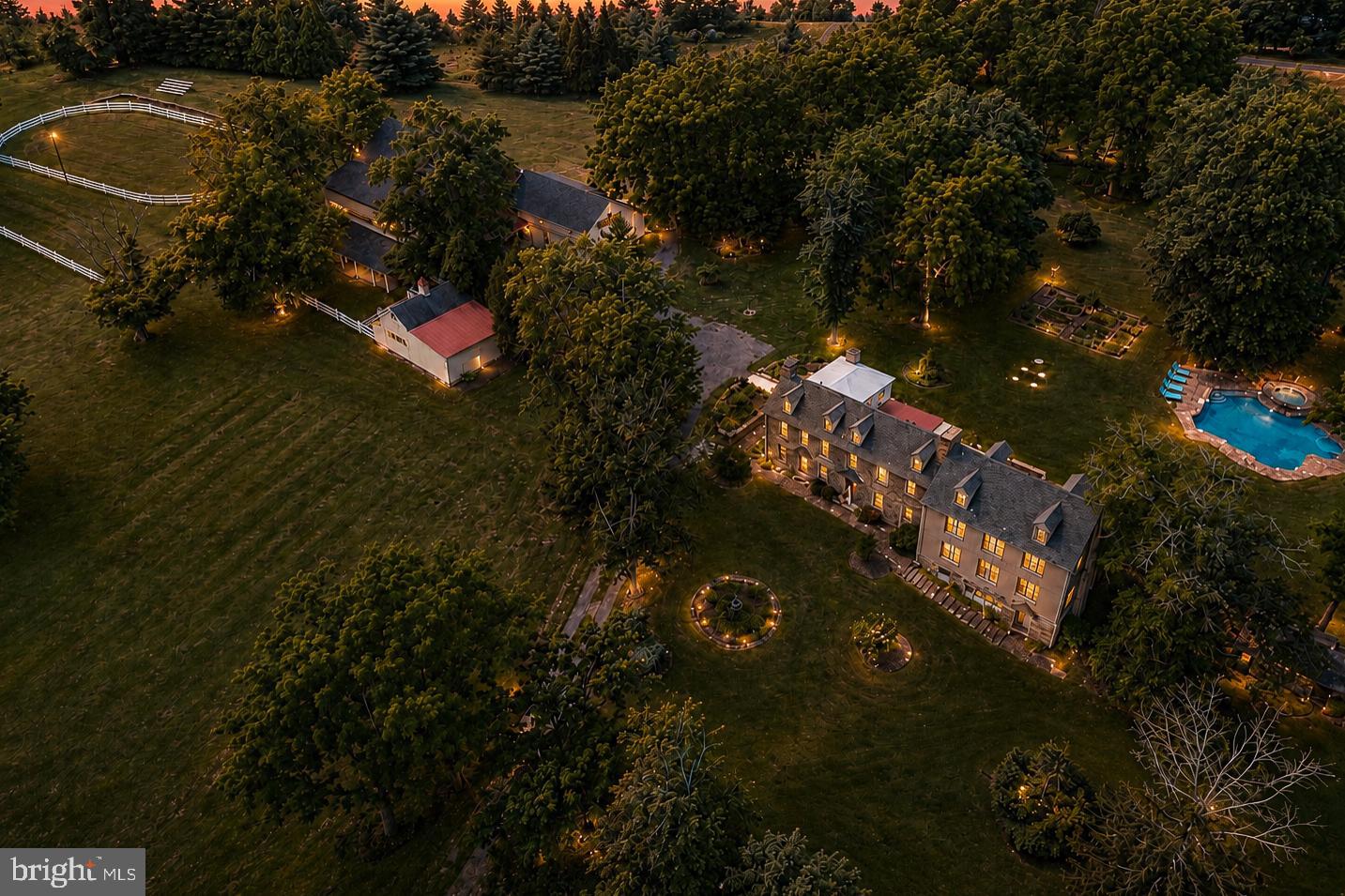 Now offered for sale, Tammany Farm presents a once-in-a-generation opportunity to own one of Bucks County's most distinguished historic estates. Privately nestled at the end of a long tree-lined driveway on 11+ breathtaking acres in Buckingham Township, bordering Solebury Township, this magnificent 1740 stone estate offers an extraordinary blend of timeless architecture, exceptional privacy, and refined country living. Ideally situated along the coveted Carversville Road corridor, the property is surrounded by preserved farmland, historic stone homes, and some of Bucks County's most picturesque countryside, just minutes from Doylestown, New Hope, and Peddler's Village.

Encompassing over 6,000 square feet, the light-filled residence showcases beautiful exposed stone walls, wood beams, hardwood flooring, multiple fireplaces, and expansive windows framing breathtaking views of the surrounding grounds. At the heart of the home, the inviting country kitchen features exposed beams, a fireplace, pantry, generous dining area, and direct access to the expansive stone patio and in-ground pool, creating a seamless indoor-outdoor lifestyle. The distinguished study, with rich wood-paneled walls, custom built-ins, and a fireplace, evokes the timeless charm of an English country library, while the billiard room provides another elegant space for entertaining.

A hallmark of Tammany Farm is its two private primary suites, an exceptional feature in a home of this era, offering outstanding flexibility for multigenerational living or extended family. Four additional bedrooms and three full bathrooms complete the second level. The expansive walk-out lower level with a fireplace provides exceptional flexibility for entertaining, recreation, a media room, home gym, or game room, while the walk-up third level offers abundant storage and exciting potential for future finished living space.
Beyond the residence, beautifully landscaped grounds feature an inviting in-ground pool, expansive stone patio, mature trees, the original spring house, and a detached two-car garage, creating an extraordinary setting for entertaining, relaxing, and enjoying the surrounding countryside. Complementing the estate is an exceptional historic stone barn featuring four horse stalls, tack room, hay storage, automatic watering system, fly spray system, and a professionally lighted riding ring. Above the barn, a private one-bedroom apartment offers exceptional flexibility for guests, a caretaker, trainer, or extended family.

Rich in history and surrounded by one of Bucks County's most breathtaking landscapes, Tammany Farm is more than a home - it's a legacy. A rare opportunity to own one of Bucks County's truly iconic properties.
