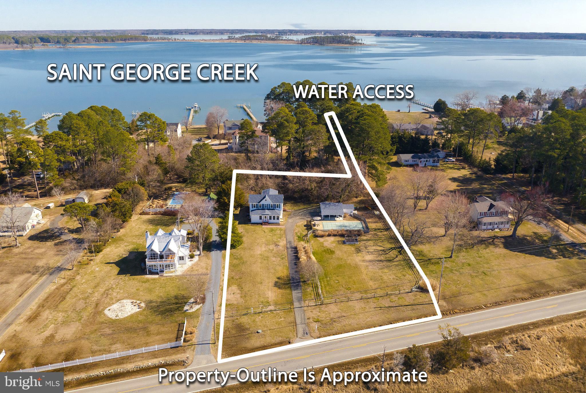 Welcome home to this delightful farmhouse with deeded water access to the St George Island Creek and picturesque Potomac River sunsets! The kitchen is lovely and was remodeled in 2019 to include new granite countertops, stainless appliances, new lighting and new flooring. The open concept floorplan provides water views from most of the first floor.  A main level bedroom can be used for guests or a quiet work-space from home. Downstairs you will also find a full tile bath that was completely remodeled.  On the front of the house, the enclosed sunroom offers the perfect spot to curl up with a book or enjoy the most spectacular sunsets imaginable.  On the second level you will find the primary bedroom and two additional bedrooms and another full bath. The sprawling one acre property includes an inground pool (new tile and pump in 2019) and a pool house connected to the one car garage.  The big ticket items have already been taken care of-new roof and siding on the house in 2019, new furnace 2020, new heat-pumps in 2021, hot water heater, bladder tank and well pump in 2017 and several new windows. The crawlspace was entirely redone and remediated in 2024, as well as the roof of the garage and shed in  2023.
Nothing to do here but enjoy the laid back days of "island life"....crab, fish, and swim at your leisure!