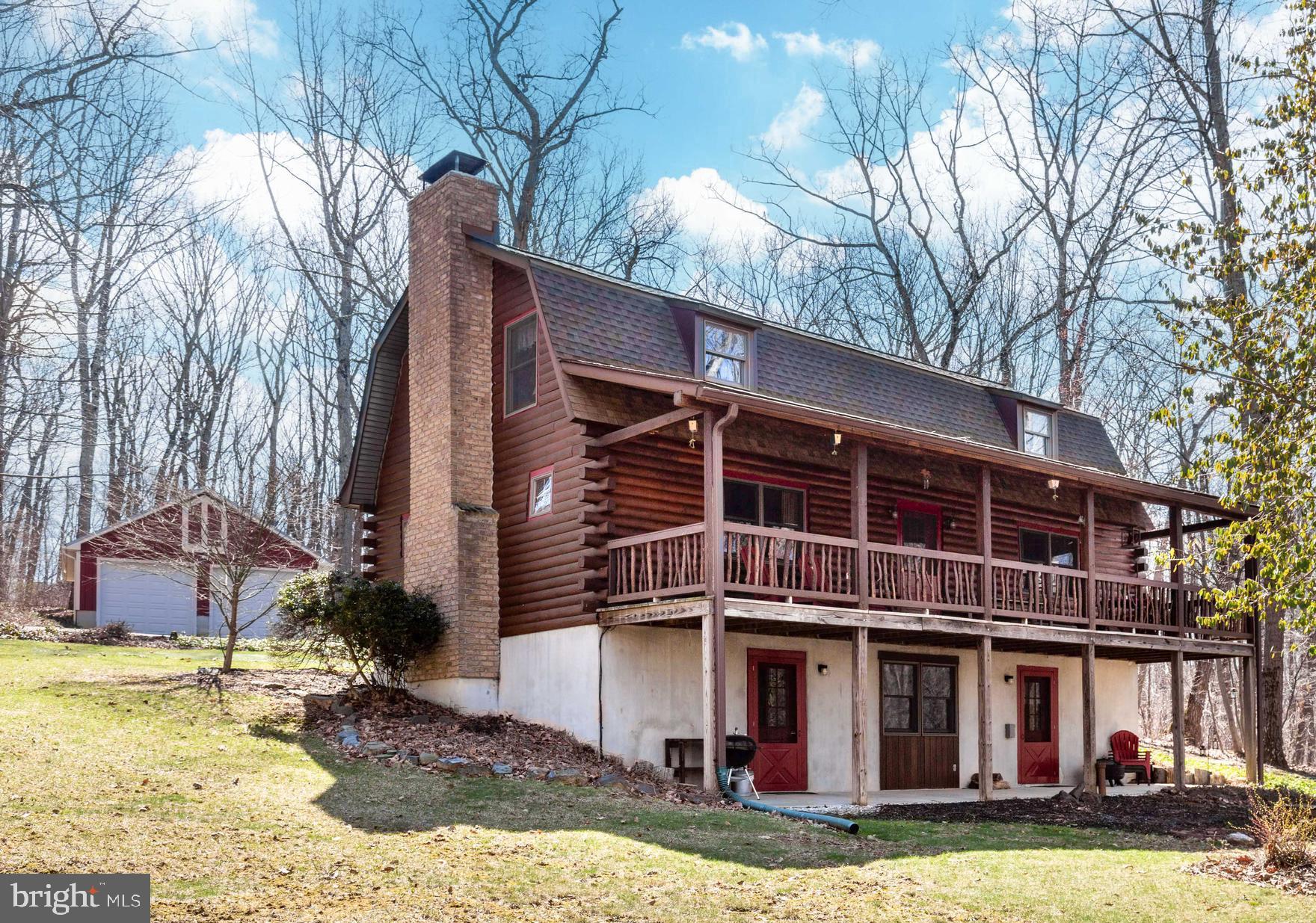 *Nestled on a private 2.62-acre setting in northern Westminster, this custom log cabin offers the perfect blend of rustic charm & thoughtful updates*Surrounded by nature & tucked away for privacy, this one-of-a-kind retreat delivers warmth, character & versatility across three finished levels*Step up to the stunning 40’ x 7’ covered front porch featuring a custom log banister, exposed beams & endless potential to screen in down the road*It’s truly an amazing space to relax & unwind*Inside, the spacious family room showcases cherry hardwood floors, exposed log walls, wood ceilings, exposed beams & a brick mantle with serviced wood stove—creating the ultimate cozy gathering space*Double-pane wood-framed Andersen windows throughout the home provide abundant natural light while maintaining energy efficiency*The dining room continues the rustic aesthetic with exposed beams & bright, inviting space for entertaining*The country kitchen features real custom hickory cabinetry & timeless appeal*The main level full bath offers ceramic tile flooring, soaking tub/shower combo, exposed wood accents & pedestal sink*The lower level provides exceptional flexibility with its own second kitchen complete with tile backsplash, electric oven/range, large freezer & neutral décor—ideal for guests, extended stays or multi-generational living*A living room with ceiling fan, full bath with new luxury vinyl plank flooring & walk-in shower, and a rec room with walk-out to the front patio expand the living space even further*Utility features include two large 150-amp electric panel boxes, regularly serviced oil-fed furnace, newer well pump & pressure tank (2022), and a regularly maintained softener/neutralizer system with filter serviced by Carroll Water Systems*The laundry room includes washer, dryer, laundry tub & built-in storage*Upstairs, you’ll find three bedrooms including a spacious 17’ x 18’ primary bedroom with exposed wood & new carpet (2023), plus a private primary bath with ceramic tile flooring & walk-in shower*Two additional bedrooms—one with wide plank hardwood flooring & charming window seat—continue the home’s warm log cabin aesthetic*Nearly 2,000 sq feet of finished living space*The detached two-car garage & newer paved driveway add convenience, while yearly servicing of the wood stove chimney, water system, oil burner & septic offer peace of mind*If you’ve been waiting for a private log home with acreage, character & major system updates already handled—this is it*