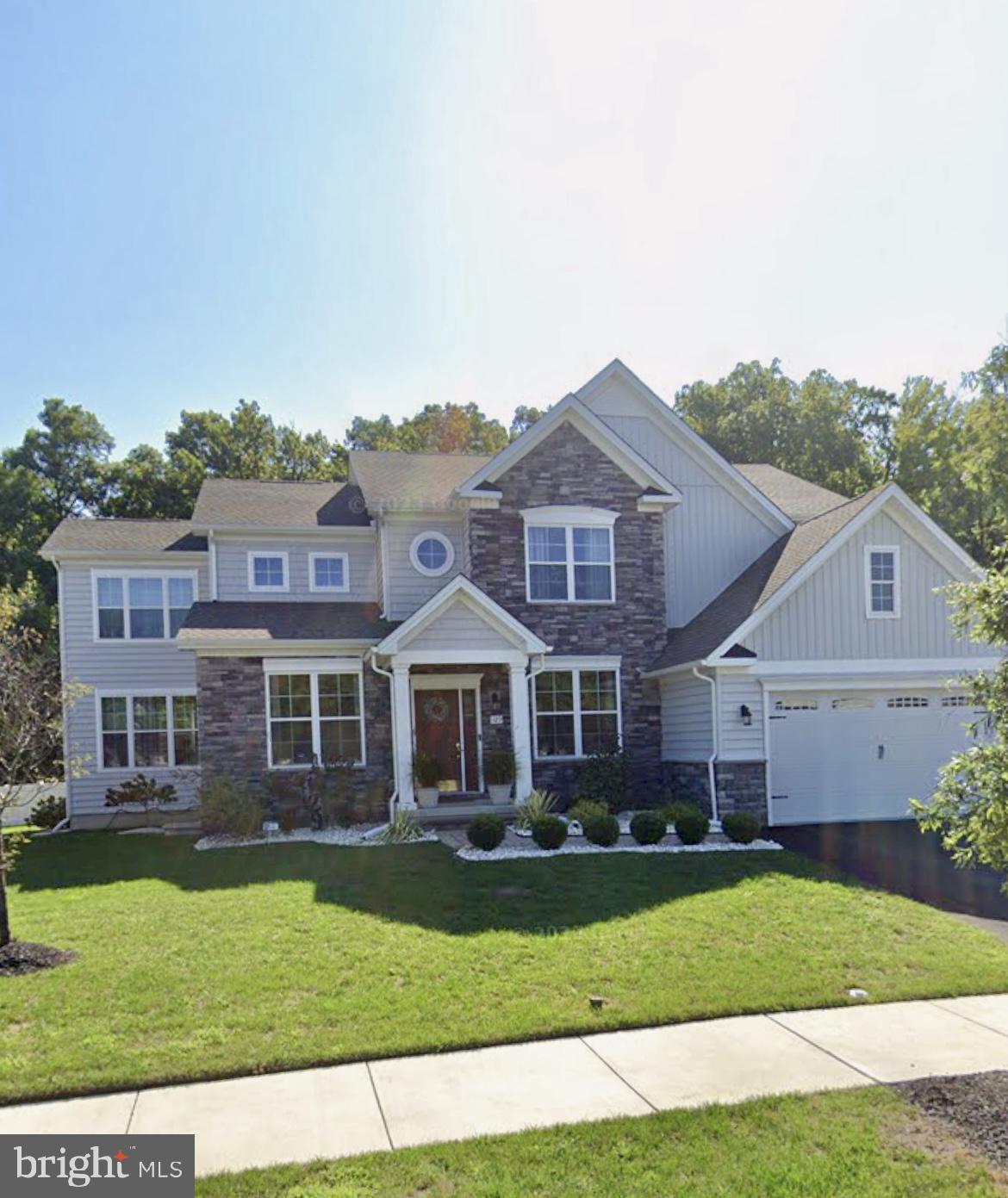 SPECIAL DURING JULY 2026: RECEIVE $10,000 CLOSING COST ASSISTANCE WITH ACCEPTABLE OFFER! Back on the market due to the buyer’s financing falling through. Welcome to the largest home in Meridian Crossing! Masterful design meets modern luxury in this stunning 6-year-old contemporary stone Colonial offering an impressive 6,215 square feet of finished living space. This expansive 5–6 bedroom, 3½-bath home delivers exceptional scale, thoughtful upgrades, and elegant architectural details throughout. From the moment you arrive, curb appeal shines with manicured landscaping, new hardscaping, decorative columns and barn-style two-car garage doors. Inside, natural light pours through walls of windows, illuminating 9-foot ceilings, designer lighting, and rich hardwood and LVP floors that flow seamlessly across every level of this gorgeous home (No carpet!). The formal living and dining rooms showcase classic crown molding, while the breathtaking gourmet kitchen serves as the heart of the home, perfect for entertaining on any scale. Highlights include a 36-inch gas cooktop with pot filler, professional range hood, electric double wall oven, in-drawer microwave, farmhouse sink, side-by-side touchscreen SMART refrigerator, quartz countertops, upgraded white cabinetry with glass uppers, full-wall designer backsplash, butler’s pantry, oversized center island with seating, breakfast bar, and a separate dining area. An adjoining morning room opens to the deck through sliding glass doors, ideal for morning coffee or sunset views, while the centrally located great room invites gathering and relaxation. A stylish powder room, an oversized pantry off the garage that was converted to a second laundry room, complete the main level. Upstairs, retreat to the spacious owner’s suite, featuring two walk-in closets, including a boutique-style dressing room with custom organizers valued at over $10,000 and charming farmhouse doors. The spa-inspired owner’s bath includes a water closet, Jacuzzi whirlpool tub (with a second hot water heater), and a European-style shower. Three additional generously sized bedrooms, a full hall bath, linen closet, and convenient second-floor laundry (two laundry rooms in the house) complete this level. The fully finished basement significantly expands the living space, offering two additional bedrooms (one ideal for a home office), a full bath, exercise room, bar area, and abundant storage, bringing the home’s total finished space to an exceptional 6,215 square feet. The private fenced-in yard backs to wooded open space, enhancing the home’s tranquil setting. Located in the prestigious Meridian Crossing community, residents enjoy low-maintenance living with an association fee that covers lawn care, snow removal, trash service, and access to a luxury clubhouse with pool, fitness center, picnic areas, and movie room. Conveniently located minutes from Route 1 and I-95. This remarkable home offers space, style, and sophistication rarely found—schedule your private tour today.