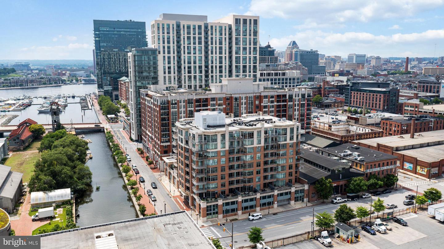 Highly desirable Harbor East 2 level condo, with 2 separate balconies, giving you awesome views of Fells Point and Harbor East attractions.  24 hour security and front desk lobby.  Private garage parking too.  This condo is in excellent condition.  Gourmet kitchen featuring granite countertops, stainless steel appliances, ceramic tile backsplash, pull-out cabinet drawers & breakfast bar.  All new vinyl plank flooring and freshly painted rooms throughout the condo.  Custom-built wall cabinets & shelves in the living room.  Very spacious exterior patio terrace off the main level.  2nd level bedrooms, bathrooms & laundry room.  Primary bedroom with private balcony, private full bathroom with large soaking tub & separate shower and walk-in closet.  2nd bedroom also features a private full bathroom.  Very open main level layout.  Just a short walk to Whole Foods, bars, restaurants and much more.