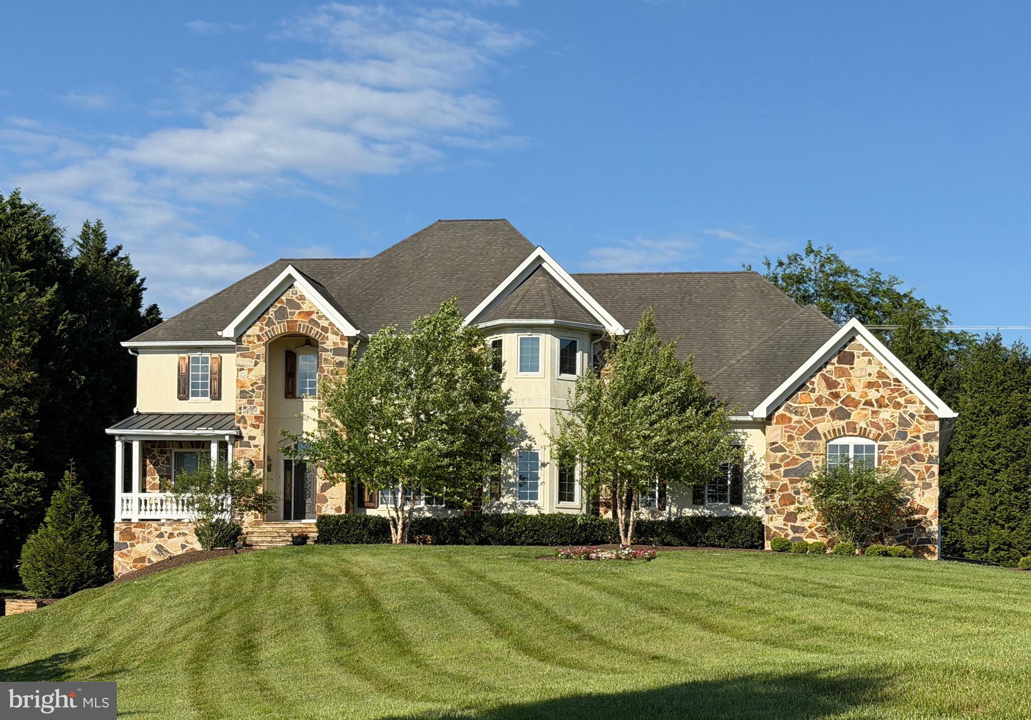 One of only 22 homes in the Hayfields Country Club and Golf Course community, this exceptional custom estate is gracefully positioned on more than one acre overlooking the 9th tee and tucked away on a quiet cul-de-sac. Offering over 7,500 square feet of beautifully finished living space across three levels, this remarkable residence blends timeless elegance with exceptional craftsmanship and modern luxury.

A dramatic two-story foyer with a sweeping curved staircase sets the tone upon entry, while 10-foot ceilings on the main and lower levels, 9-foot ceilings on the upper level, and 8-foot solid-core doors throughout the main and lower levels create a grand sense of scale and quality. Solid-core doors continue throughout the upper level, further reflecting the home’s superior construction and attention to detail. The thoughtfully designed floor plan offers six bedrooms, five full baths, and one half bath, along with two additional flex rooms ideal for home offices, libraries, studies, or dens. An additional rear staircase provides convenient access to the upper level.

The expansive lower level is perfectly suited for multi-generational living or extended guest stays, featuring a private in-law suite with its own entrance, spacious living and dining area, kitchen, large bedroom with walk-in closet, full bath, and private stone patio. Entertainment and wellness are equally impressive with a private theater and media room featuring a premium 13.2-channel Dolby Atmos surround sound system for a truly immersive cinematic experience, a professional-grade fitness center, and a dedicated massage room.

Additional highlights include a 3½-car garage with soaring 13-foot ceilings, generous room sizes throughout, and picturesque golf course views. Ideally located less than one mile from I-83 and under two miles from Hunt Valley Towne Centre, this extraordinary residence offers a rare opportunity to enjoy luxury living in one of Baltimore County’s premier golf course communities.