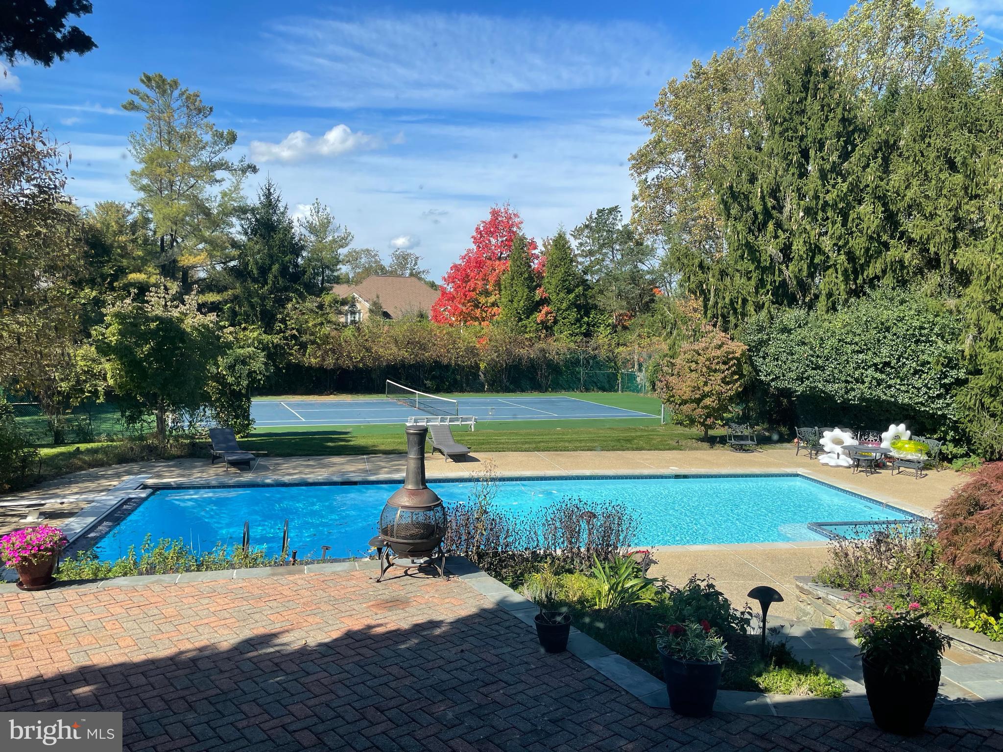 Welcome to the heart of Potomac.  6,200 + sq ft, 5-bedroom, 6.5-bathroom masterpiece.  Positioned in a prime location, this home redefines luxurious living, offering an oasis of serenity with an impressively large pool and tennis court, ensuring endless outdoor entertainment for you and your loved ones.
This property's location is a homeowner's dream, with unparalleled access to all amenities. Not only does it feature a 2-car attached garage, but it also includes a separate 2-car garage complete with an in-law suite, perfect for hosting guests or accommodating extended family. 
Inside, you'll find an abundance of natural light and a thoughtfully designed circular floor plan that's perfect for large-scale entertaining. From the dramatic vaulted ceiling in the family room to the formal living and dining areas that can comfortably seat 12 or more, this home offers a grand stage for your gatherings. A separate library provides a quiet retreat, and the kitchen with its elegant quartz center island is a chef's delight.  Additionally, there's an au pair suite, adding versatility to your living space.
Neutral wall space and stunning hardwood floor throughout create a sophisticated backdrop, just waiting for your personal touch. The outdoor space is equally enchanting, featuring a sprawling paver patio that's ideal for hosting events while basking in beautiful sunsets.
This property is an entertainer's paradise, with a pristine pool boasting inviting blue waters, a tennis court, a golf putting green, and lush gardens with mature trees and greenery that ensure peace and quiet behind a private fence, making every season truly wonderful.  
This home is a sanctuary that perfectly encapsulates the charm of Potomac living. It's offered AS IS with numerous upgrades, creating an exceptional canvas for you to transform into your dream home. Don't miss this rare opportunity to make this remarkable property your own.