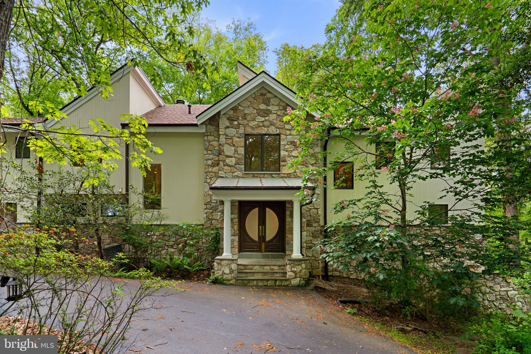 Professional Photos are Coming Soon

There are homes built for living… and there are properties created for those seeking something far more rare—space to breathe, room to dream, and a setting that restores the soul.

Hidden quietly behind mature trees and surrounded by approximately six breathtaking acres that feel more like a private nature preserve than a residential homesite, this extraordinary Great Falls estate offers a lifestyle few properties can replicate. Tucked away from the noise and pace of everyday life, 10701 Sycamore Springs Lane is a retreat where peace, privacy, and possibility exist in perfect harmony.

From the moment you arrive, the experience feels different. A circular driveway winds through the wooded landscape, creating a grand yet understated arrival. The detached three-car garage and oversized parking area provide exceptional functionality for gatherings, car enthusiasts, or multigenerational living. Everywhere you look, nature takes center stage.

Inside, the home unfolds with over 6,000 square feet above grade and an additional 1,800 square feet in the lower level, offering an incredible canvas for someone with vision to create a truly remarkable forever home. Designed to embrace the surrounding landscape, walls of glass blur the lines between indoors and out, flooding the interiors with natural light while framing serene views in every season. Morning sunlight filters softly through the trees. In the evenings, the setting becomes calm, quiet, and almost cinematic.

The scale of the home is both grand and inviting. With six spacious bedrooms and four and a half baths, there is ample room for extended family, guests, entertaining, or creating dedicated spaces for work, wellness, hobbies, or private retreats. Five fireplaces add warmth, character, and architectural presence throughout the home, creating intimate spaces within the expansive layout.

This is a property that speaks to a buyer who values authenticity over trends and understands the rarity of land, privacy, and setting in Great Falls. The next owner may choose to thoughtfully renovate and restore its timeless character, reimagine the interiors with modern luxury finishes, or create a legacy estate tailored entirely to their vision. The foundation is already here: exceptional scale, extraordinary grounds, timeless architecture, and a location that continues to be one of Northern Virginia’s most sought-after luxury communities.

Outside, the acreage feels endless. Towering trees, open green space, and the natural landscape create an environment that feels secluded and restorative. Whether enjoying coffee while listening to birdsong, hosting elegant outdoor gatherings under the stars, or simply appreciating the stillness that surrounds you, this property offers something increasingly difficult to find—a true sense of escape without sacrificing convenience.

Located in prestigious Great Falls, this home offers the best of both worlds: a tranquil, estate-style setting with close proximity to major commuter routes, Tysons, Reston, Washington Dulles International Airport, and the technology corridor. Yet once you arrive home, the outside world feels miles away.

Properties like this are not defined by perfection. They are defined by potential, emotion, setting, and the lifestyle they make possible. For the buyer searching for privacy, serenity, architectural character, and the opportunity to create something truly special, the search is over.
