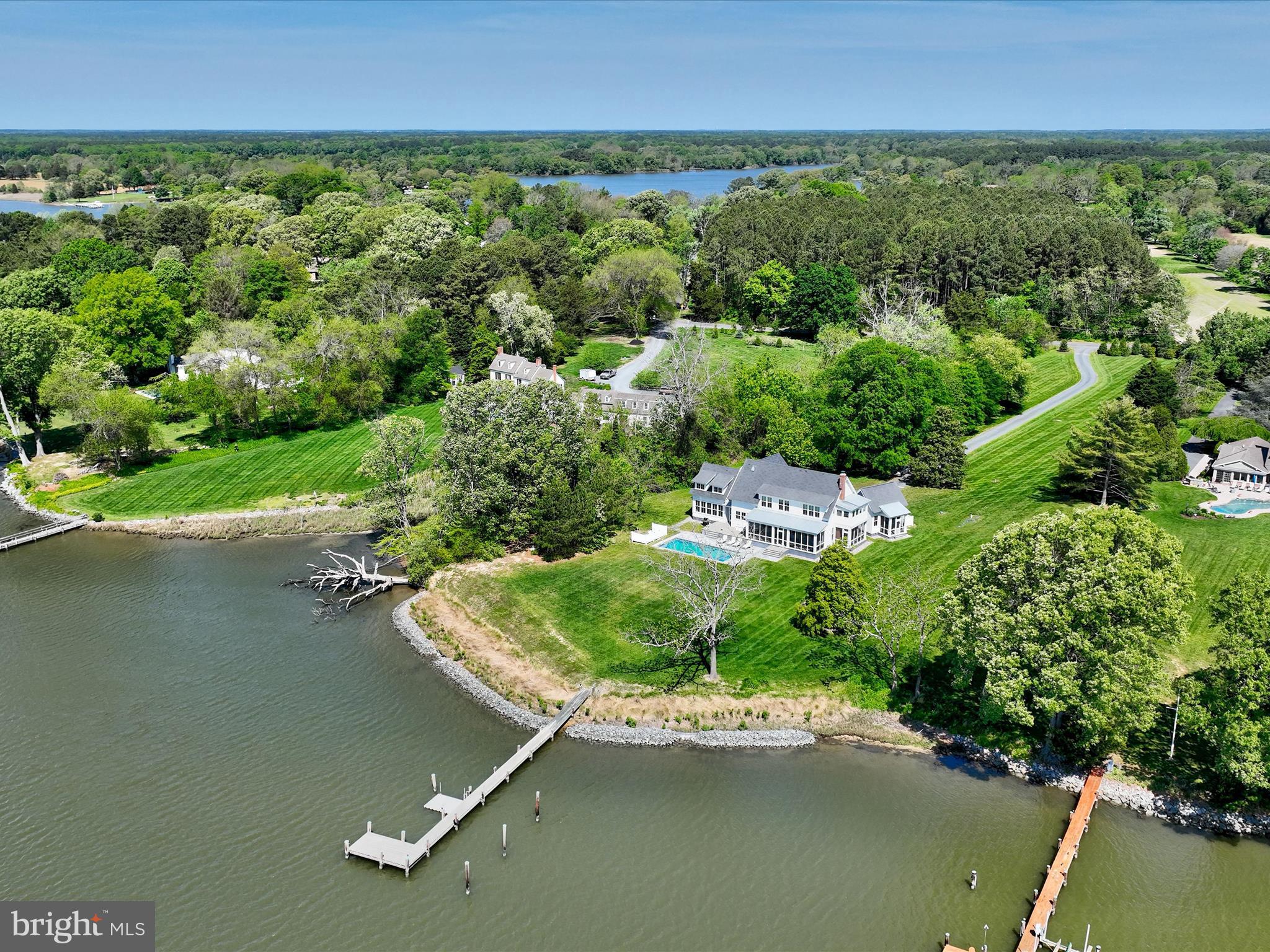 Stunning Ilex-built modern farmhouse set on over 3 acres along scenic Glebe Creek. This thoughtfully designed home features open-concept living with seamless sight lines from the kitchen through the dining area to the living room, creating an ideal space for everyday living and entertaining. A spacious screened-in porch extends from the main living areas and leads out to a waterside pool with an automatic cover and heater—perfect for enjoying indoor-outdoor living year-round.

Just off the mudroom, a sunny family room offers a cozy gathering space. The main level also includes a private guest suite tucked away for maximum privacy, complete with a loft, ensuite bath, and its own screened porch. Additional highlights on the main floor include a powder room, a butler’s pantry with laundry, and a screened porch off the living room.

Upstairs, the serene primary suite features a beamed ceiling, custom built-ins, an elegant ensuite bath, and a private sleeping porch. A separate children’s wing includes two charming bedrooms, each with dual built-in beds, and a shared bath. Two additional bedrooms, a hall bath, a walk-in linen closet, and a laundry closet complete the upper level.

Outside, a detached three-car garage includes a converted bay, now serving as an exercise room. Enjoy waterfront living with a private dock featuring a floating dock, riprapped shoreline, and picturesque pool area—everything you need for a peaceful retreat or active lifestyle.

Easton, Maryland, known as the New Hamptons of the Chesapeake Bay by Forbes Magazine, is conveniently located 1.5 hours from D.C. and Baltimore, and 2 hours from Philadelphia. Just minutes from fine dining, shopping, healthcare, theatres, galleries, museums, golf courses, a country club, a yacht club, and a jet airport.