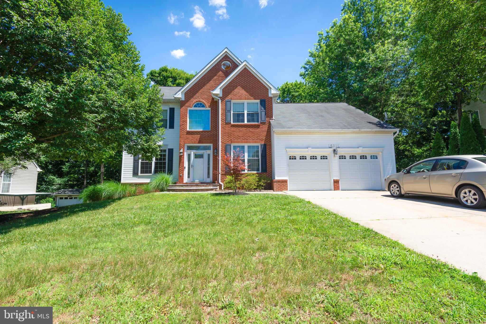 Welcome to this spacious Colonial nestled on a private lot backing to woods, offering timeless charm, generous living space, and endless potential. Featuring 4 bedrooms and 3½ baths, this home boasts a versatile floor plan with both a first-floor primary suite and a second-floor primary suite—ideal for multi-generational living or flexible guest accommodations.  Step inside the dramatic 2-story foyer with hardwood floors and a baby grand piano that conveys. The updated kitchen is the heart of the home, complete with granite countertops, stainless steel appliances, double wall ovens, cooktop with hood, and a built-in breakfast table. Entertain with ease in the formal dining room, spacious family room with fireplace, or relax in the sunroom just off the dining area overlooking peaceful wooded views. The second-floor primary suite features an updated bath with a walk-in shower and soaking tub, creating a private retreat. Additional highlights include a laundry room, unfinished basement offering abundant storage or future expansion possibilities, attached 2-car garage, and concrete driveway. A large deck overlooks the wooded backyard, providing the perfect setting for outdoor gatherings or quiet mornings. Being sold as-is, this home needs TLC but offers an incredible opportunity to make it your own and build equity in a desirable setting.  Seller offering $5000 in flooring allowance