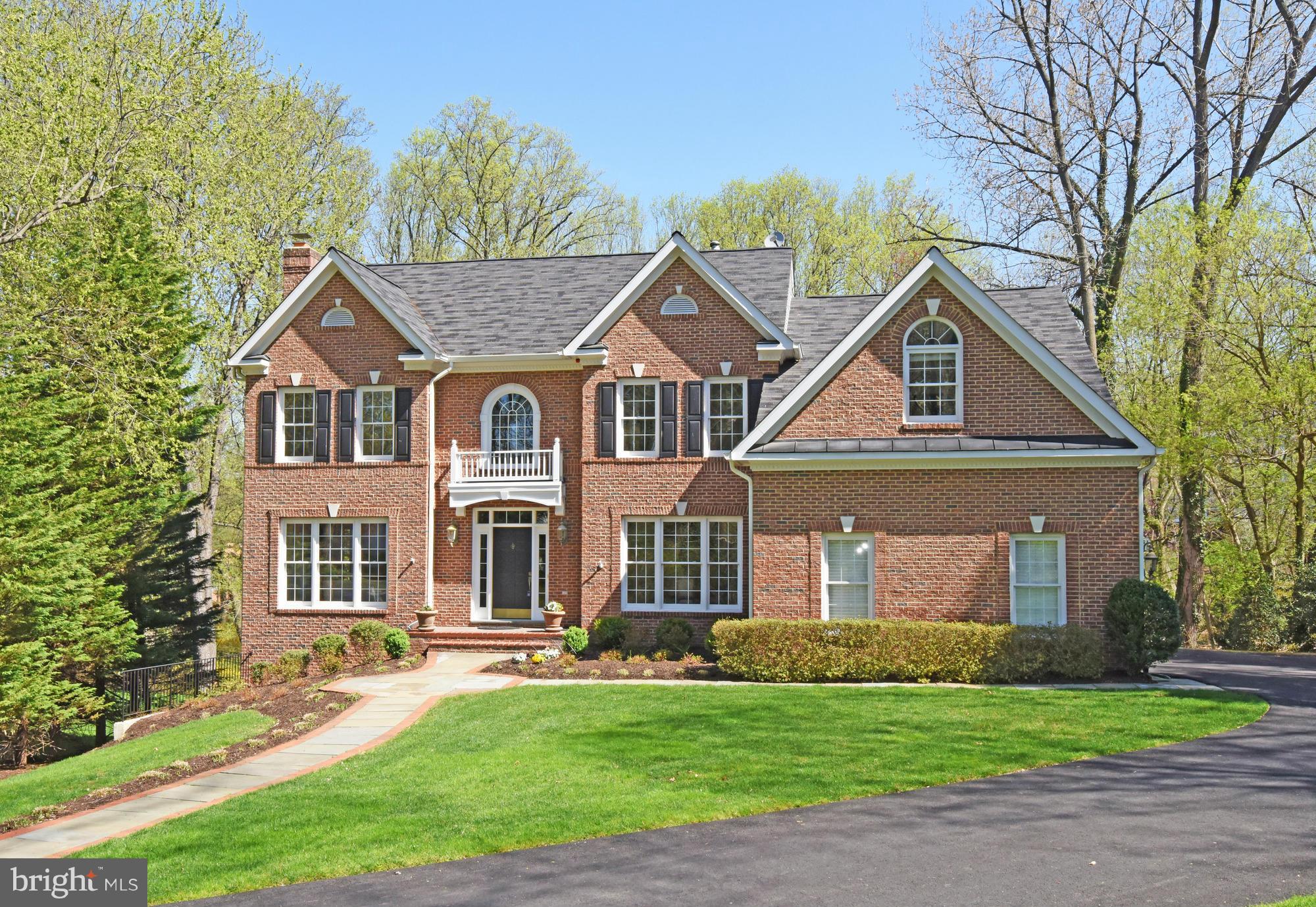 Significant PRICE Reduction! GORGEOUS, HUGE All Brick, Expanded and Renovated Colonial w/ Exceptional Features Including 5BR/4.5BA,  Master Suite & Sitting Room w/ FP, New  Master Bath,4 Car Garage Spaces,1/2 acre Private Lot Backing to Trees, Gourmet Designer Kitchen, Expanded Master & 2-Story Family Room. Walk Out Lower Level to an Oversized Paver Patio.