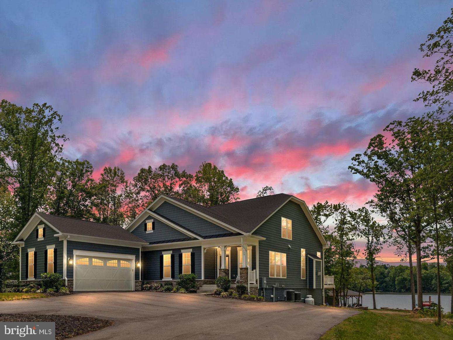 Experience the ultimate in luxury waterfront living at beautiful Lake Anna with a rare opportunity to own a stunning retreat that offers not only an incredible lifestyle, but also exceptional investment potential. 2025 revenue was over $175k. Projected 2026 rental revenue is estimated between $175,000–$225,000, making this extraordinary property a luxury waterfront home that can almost pay for itself. Consider DSCR loan and self-directing 401k make your dream a reality.  Nestled in the highly sought-after Elk Creek Landing subdivision on the private side of the lake, this resort-style oasis delivers breathtaking sunsets, huge open water views, 250 feet of pristine shoreline, and the peaceful privacy that makes Lake Anna so special.

A paved circular driveway welcomes you to this beautifully appointed waterfront retreat offering over 5,500 square feet of thoughtfully designed living space with 5 spacious bedrooms, 4 full bathrooms, and a loft perfect for kids or additional guest space. Designed for entertaining and unforgettable lake memories, the open-concept floor plan seamlessly blends luxury and comfort with upscale finishes throughout, including a dramatic floor-to-ceiling stone fireplace, expansive wet bar with oversized island, upgraded countertops, massive kitchen center island, double wall ovens, Luxury Vinyl Plank flooring, recessed lighting, Hardiplank siding, extensive hardscaping, and more. The home also features a fully equipped exercise room and an incredible media room perfect for movie nights, game days, and rainy days at the lake. High-speed fiber internet is available, allowing you to work remotely while enjoying lakefront paradise.

Step outside and immerse yourself in true waterfront resort living. Enjoy the beautiful level rear yard that gently leads down to the water’s edge, creating the perfect setting for outdoor games, gatherings, and effortless access to the lake. Wander past the fire pit down to your private waterfront playground featuring a massive boathouse with two slips, electric lifts, storage room, expansive dock bar with two roll-up serving windows perfect for unforgettable dock parties, covered lounging area, sun deck, swimming area, and your very own private sandy beach — the perfect spot to relax, swim, launch your float, or spend endless summer days on the water. Whether hosting family and friends or enjoying a quiet evening watching the sunset over the lake, every detail of this property was designed to create an unforgettable experience.

Offered furnished, this exceptional retreat allows you to move in and immediately begin enjoying the Lake Anna lifestyle or continue operating it as a highly desirable luxury rental investment. Conveniently located approximately 45 minutes from Richmond and about 90 minutes from Washington, you'll enjoy easy access to local waterfront dining, shopping, groceries, entertainment, and everyday conveniences while still enjoying the privacy and tranquility of lakefront living. Schedule your private tour today and discover what luxury waterfront living at Lake Anna is truly all about.