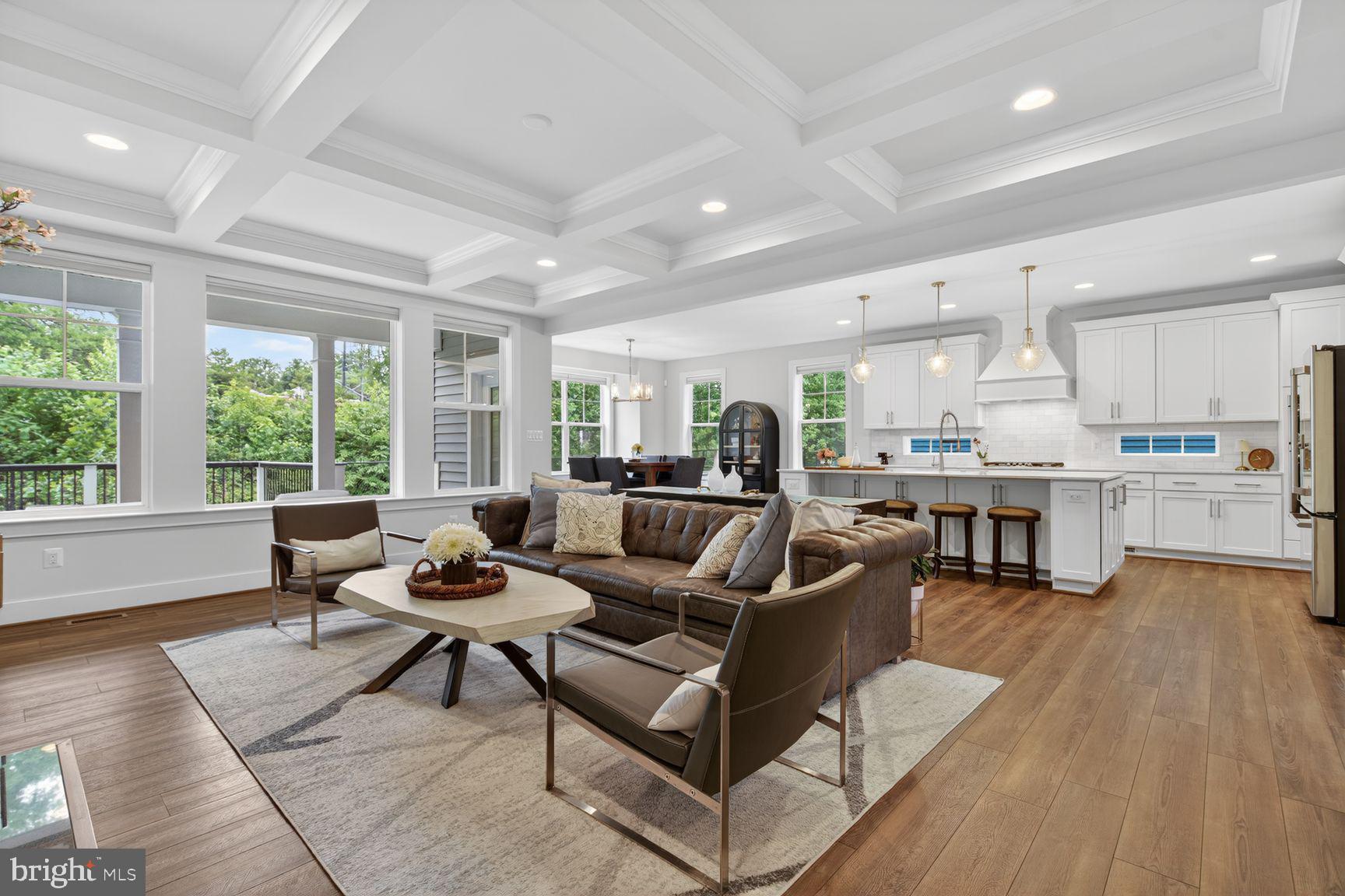 Better than new and impeccably upgraded, this 2022-built Taylor model in the sought-after Residences at McConnell Manor delivers luxury, space, and energy efficiency in one of West Springfield's most desirable enclaves. Customized at the build with over $240k in upgrades, both side and rear extensions, it lives large across three finished levels with a bright, open floor plan made for everyday living and entertaining.
The designer gourmet kitchen anchors the main level with an extended island, upgraded gas appliance package, and decorative hood, opening to a tray-ceilinged dining room, a butler's pantry, and a great room finished with a custom box-beam ceiling and an upgraded gas fireplace with black stone surround. A drop-zone with built-in bench and storage keeps daily life organized, while bay windows in the breakfast room and main-level study brighten the home. Upgraded touches are everywhere: a quartzite vanity in the owner's suite, on-trend matte black plumbing fixtures, custom closet built-ins in the owner's suite and designer two-way blinds throughout. The owner's suite features a tray ceiling and spa-inspired bath; a second-floor buddy bath serves the additional bedrooms.
The walk-out lower level offers a rec room, dedicated exercise room, full bath, and a wet-bar rough-in ready to finish. Outside, enjoy a Trex deck/porch stepping down to a stone patio, a stone retaining wall, fruit-bearing persimmon trees, and a lush lawn served by an in-ground sprinkler system. More highlights: ENERGY STAR® and NGBS-certified construction, HVAC humidifier, gutter guards, motion-sensor flood lights, smart-home wiring with TV/data connections in every bedroom and living area, a conveying Tesla EV charger, smart washer/dryer, conveying ADT security equipment, a high-ceiling garage ideal for overhead storage, and a driveway that fits four vehicles.
Walkable to West Springfield High School, with a community trail through preserved woods, and minutes to commuter routes, shopping, and dining.
