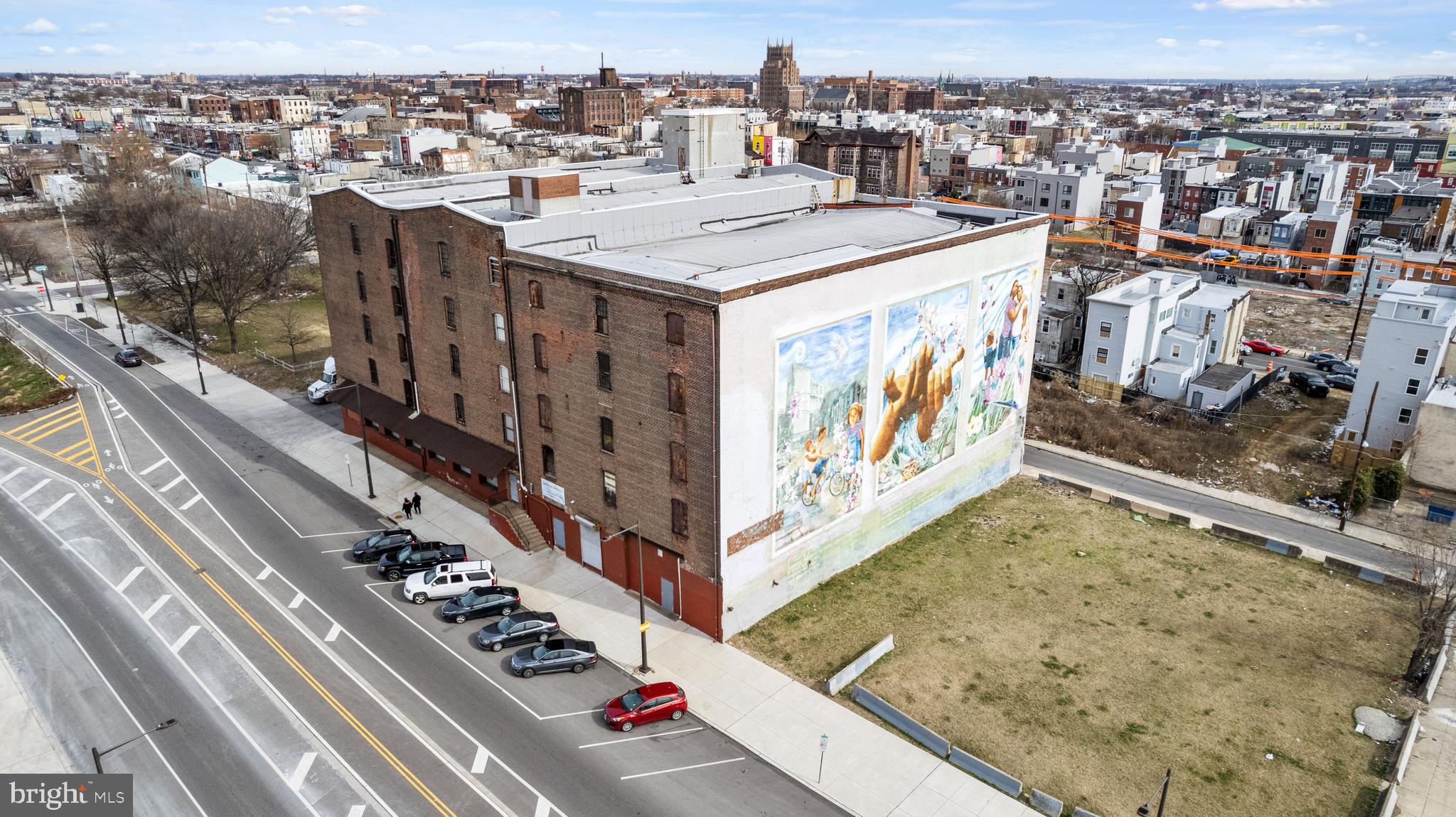 Introducing 2401–23 N American Street, a rare opportunity to acquire two contiguous parcels in a rapidly evolving section of Philadelphia, offering significant scale and flexibility for a variety of industrial, commercial, or redevelopment uses.
The first parcel, 2401–11 N American Street, is a 12,175 square foot vacant corner lot with excellent visibility and accessibility. Its corner positioning and open layout make it well-suited for ground-up development, outdoor storage, or a range of commercial and industrial applications.

Adjacent to it, 2413–23 N American Street features a five-story industrial warehouse with an additional lower level, totaling 110,000+ square feet of interior space. Situated on a 22,960 square foot lot with a 19,000 square foot building footprint, the property is equipped with two freight elevators, two stairwells, and three loading docks, supporting efficient vertical and logistical operations. The building lends itself to continued industrial use, adaptive reuse, or repositioning as creative or mixed-use space.

Together, the parcels provide a unique combination of existing scale and development potential, making this offering ideal for users, investors, or developers seeking a presence in a high-growth corridor.