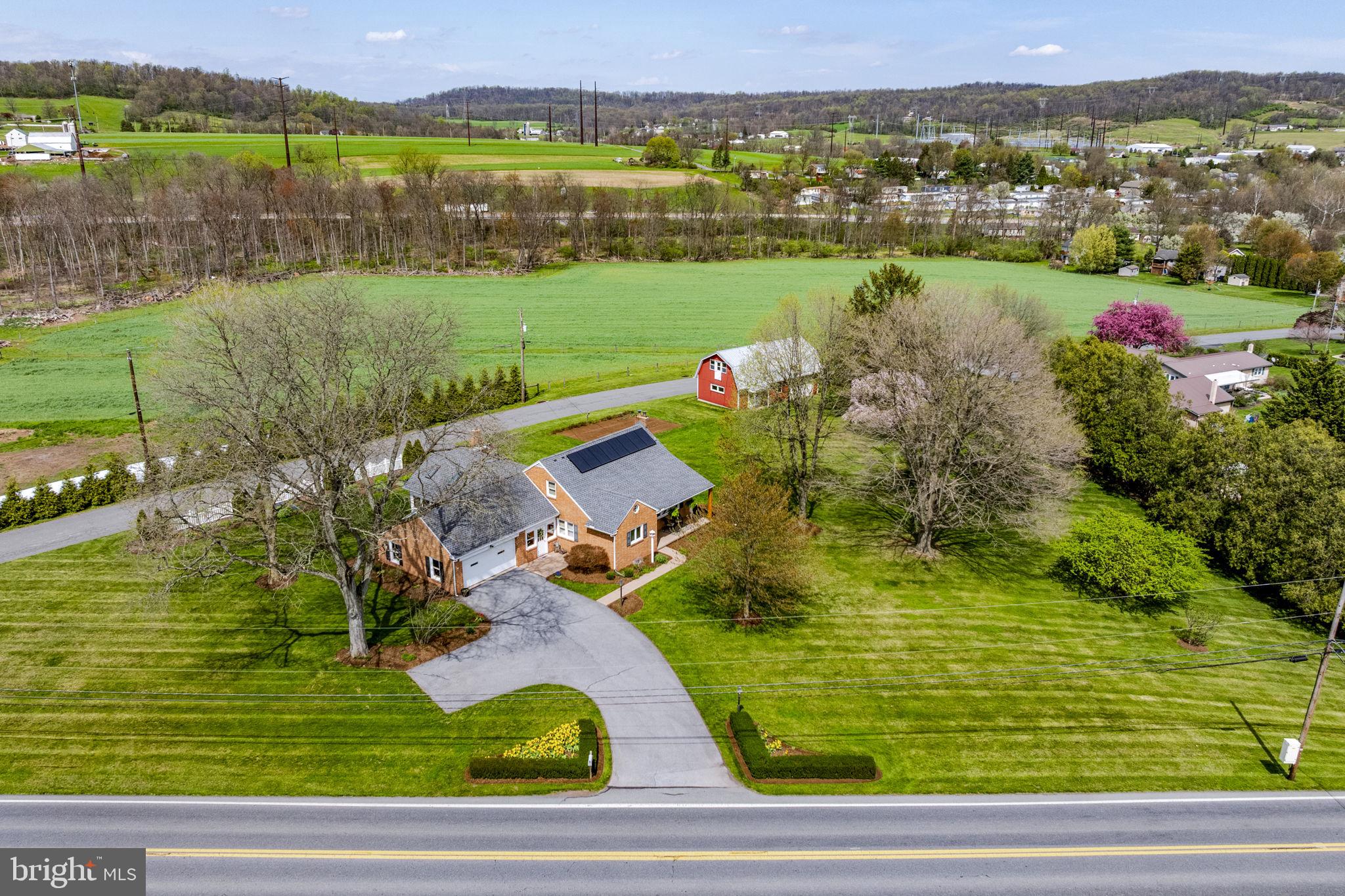 AUCTION DATE - TUESDAY, JUNE 23, 2026, AT 5 PM. LISTED PRICE IS AN OPENING BID ONLY AND IS NOT INDICATIVE OF THE FINAL SALE PRICE. REAL ESTATE: 1½ story solid brick house w/2998 SF finished area w/eat-in kitchen w/oak custom cabinets w/raised panel doors, Corian counter tops, pantry & appliances, dining area, living room w/picture window, enclosed heated breezeway, 3 bedrooms (1st floor primary bedroom), 1½ baths, nursery (could be 4th bedroom), spacious rear sunroom 22x18 w/cathedral ceiling, French doors & lots of windows, beautiful hardwood flooring, basement w/rec. room, storage & utility rooms, oil HW, central AC, low maintenance exterior w/covered soffit, fascia & insulated tilt windows thru out, covered front porch & patio area, attached 2-car garage. Outbuilding: 2 story frame w/painted steel shop/garage 42x22 w/overhead door, heated, 100 Amp service, 21x15 shop area, 22x16 garage, 2nd floor storage rooms all on level 1½ ACRE country lot w/rear lawn & garden area, mature shade, professional landscaping, on-site well & public sewer. NOTE: Ideally located country property. A truly must-see, well-kept property in move-in condition. Minutes to Rts. 625, 897, 222 Bypass & Turnpike. Terms 10% down, balance 60 days or before. Personal inspection by appointment or open house Sat., June 6, 13 & 20 from 1 to 4 PM.