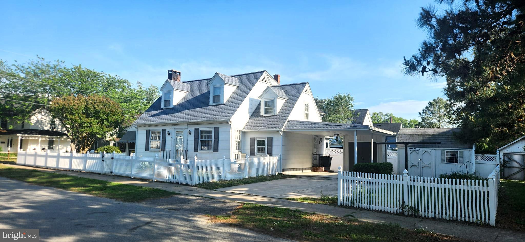 Welcome to this Lovey Cape Cod  situated on a corner lot surrounded by a vinyl picket fence. It boasts hardwood flooring through out the main rooms and has strong bones and it is noted for being very easy to heat. You can make your self comfortable while enjoying your favorite beverage on the front screened in porch. Inside a wood burning fireplace enhances the Living Room. This home offers ample space and plenty of storage inside and out and  in the basement. Having 2 full baths makes this home very accommodating.  For your additional storage needs there is secure storage under the carport and also a detached storage shed to boot... Don't miss an opportunity to make this your home.