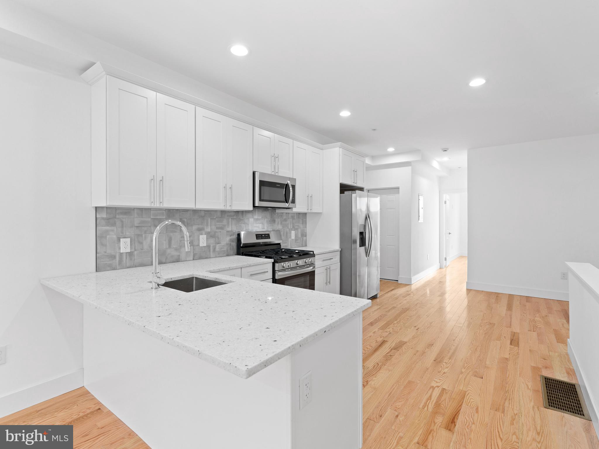 Be the first to call this exceptional, newly constructed 3-bedroom, 3-bathroom apartment in Overbrook home, Introducing 6442 Lansdowne Ave - Unit 1. This modern residence showcases a contemporary design with impressive high ceilings, stylish recessed lighting, and beautiful hardwood flooring throughout. The brand-new kitchen is a focal point, featuring a convenient breakfast bar, chic white shaker cabinets, elegant quartz countertops, and a full suite of new stainless steel appliances. Retreat to the modern spa-like bathrooms, equipped with an oversized shower for ultimate relaxation. This unit also offers generous closet space, the convenience of an in-unit washer and dryer, and the added benefit of a private parking spot in the rear. Enjoy a prime location near City Ave and the expressway, providing swift access, including a 15-minute drive to the scenic Kelly and Lincoln Drives. Embrace an active lifestyle with nearby bike trails and a golf course, and take advantage of the close proximity to diverse restaurants and shopping options. Commuting is a breeze with easily accessible train and bus lines. Schedule your private tour today!