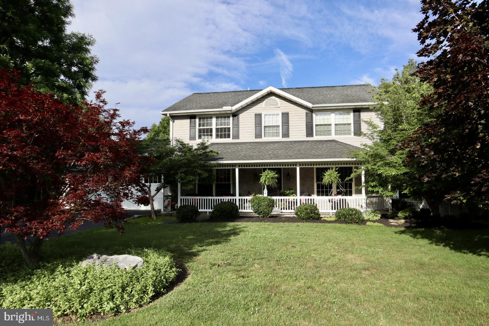 Welcome to 218 Putters Circle, where comfort, style, and family come together in the heart of Dillsburg's desirable Fairway Hills Community.  Walk to the beautiful Range End Golf Course and enjoy all the natural beauty of the area.  This meticulously maintained home offers the perfect blend of modern amenities and charm-just minutes from shopping, restaurants, and major routes to Harrisburg and Gettysburg. A gorgeous front porch sets the tone, offering the perfect place to relax and enjoy the peaceful surroundings while taking pride in the lush landscaping. Set on a .35 acre lot next to the wooded common area, the outdoor space is as inviting as the interior.  The large rear composite deck with terraced steps and retractable awning, that overlook a large hardscaped firepit and seating area making the home ideal for both everyday enjoyment and special entertaining. The interior is just as appealing as the exterior.  The hardwood flooring in the kitchen and dining room add to the rich character of the architectural details elevate every space.  The crown molding throughout, the chair rails, the built ins, and the corniches add visual interest throughout.  The remodeled kitchen, half bath, and family room with a corner gas fireplace that has built in bookshelves add to the unique charm of the home, The finished lower level provides valuable living space, an additional half bath, and a bonus room that is currently set up as an office.   
The primary master suite provides a peaceful retreat with generous walk-in closets, and a spacious well-appointed en-suite master bath.  All the bedrooms are spacious and offer many custom details.  Both bedrooms utilize the Jack and Jill bathroom, which adds to the flow of the early mornings.  Don't miss this rear opportunity to own this truly special home in a beautiful neighborhood.  Come see and make it yours!
