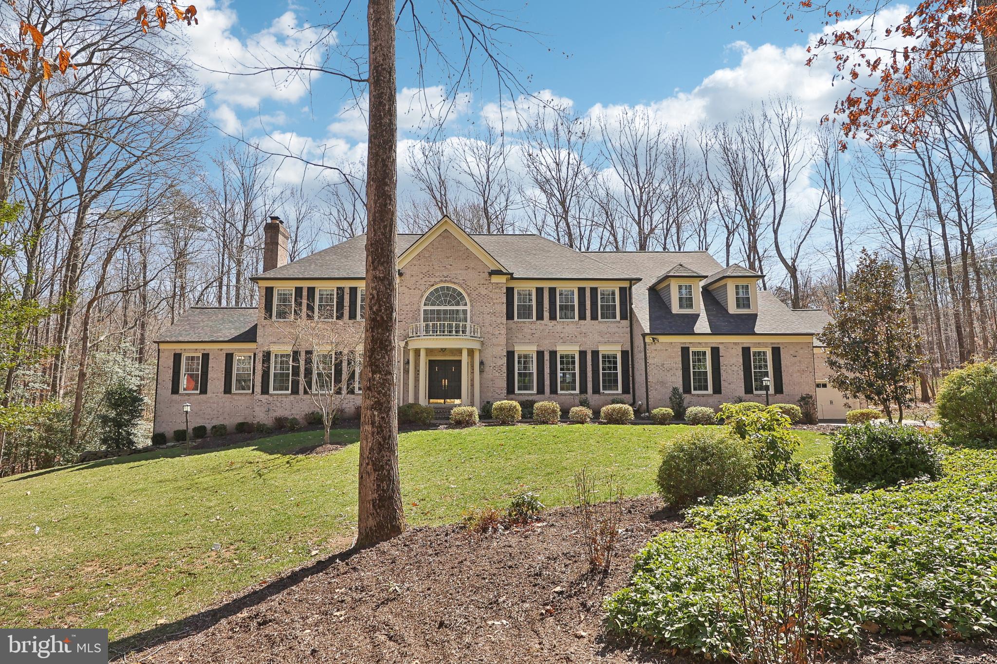Welcome to this elegant brick colonial estate, perfectly situated on a private 5-acre lot in the prestigious Briarlynn Estates community of Fairfax Station. Nestled on a peaceful cul-de-sac, this home offers a blend of timeless sophistication and modern updates and provides a relaxing retreat, just 30 minutes from DC, with Burke Lake Park and various shopping options only moments away. Ask about the 2.75% assumable VA loan!

Step into the grand two-story foyer with an open staircase, setting the tone for the spacious and light-filled interior. The main level features a chef’s dream kitchen with stainless steel appliances to include a Thermador gas cooktop, Viking double oven, sub-zero refrigerator,  a warming drawer, and ample prep space—ideal for cooking enthusiasts and entertaining. This level also includes a large, sunlit office, formal dining room with exquisite hand-painted walls, a sophisticated living room, a well-appointed mudroom, and a beautiful sunroom—perfect for relaxing and enjoying the surrounding views. The spacious family room, a true gathering space, boasts soaring ceilings and one of the home’s three gas fireplaces, adding warmth and charm.

The upper level boasts an oversized primary suite with dual walk-in custom closets, a sitting area, and a newly renovated spa-like bath featuring heated tile floors, a separate walk-in shower, and a cast iron soaking tub. Two additional large bedrooms share a Jack and Jill bath, while the fourth bedroom enjoys its own private ensuite bath.

The fully finished, walkout lower level is exceptionally spacious, offering multiple entertaining areas, perfect for a home theater, billiards, game nights, or relaxation. A fifth bedroom and a full bath make this level ideal for guests or an in-law suite. Additionally, there is ample storage space, ensuring plenty of room for seasonal items, hobbies, and organization. 

The expansive backyard, surrounded by mature trees, provides ultimate privacy and tranquility. Off the main level, step onto the large Trex deck, ideal for outdoor entertaining or quiet mornings with coffee while enjoying the peaceful, tree-lined views.

Recent upgrades include:
✔ New water heater (2024)
✔ New main-level heat pump & natural gas furnace (2023)
✔ Whole-house natural gas generator & new upgraded circuit panel (2023)
✔ Second-floor AC unit replaced (2022)
✔ New roof, siding & gutters (2022)
✔ Trex decking, four new garage doors, openers & natural gas cooktop (2020)
✔ Windows replaced (2019)

This extraordinary home offers timeless elegance, thoughtful updates, and a prime location in one of Fairfax Station’s most desirable communities. Don’t miss this rare opportunity! Schedule a private showing today!
