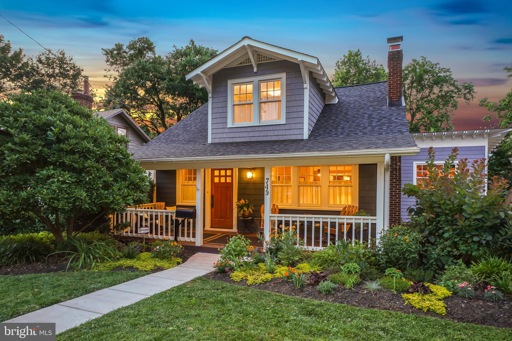 STUNNING, LUXURIOUS, AND IMPECCABLE! Rare opportunity to acquire a beautifully appointed, fully remodeled bungalow with a covered front porch and a large addition, just steps from downtown Silver Spring. Originally built in 1923 and later expanded and renovated, this magazine-worthy home perfectly blends vintage charm with modern living spaces, utilizing exquisite finishes, handsome moldings, elegant lighting, wood floors, glorious windows, five-panel wood doors, and superb architectural details throughout. Every aspect of this residence has been thoughtfully designed and enhanced—it is truly a work of art.
This picture-perfect home features an inviting covered front porch, creating incredible outdoor living space to enjoy morning coffee or chat with neighbors. Enter into the welcoming foyer that flows into the sunlit living room with a fireplace flanked by built-ins and a drum light fixture. Beyond the living room is an elegant dining room with a striking glass cone-shaped chandelier and abundant natural light, opening to the extraordinary chef’s kitchen.
The renovated top-of-the-line kitchen features a high-end stainless steel appliance package, honed soapstone countertops, a center island with sink, Viking six-burner gas cooktop with hood, two GE Monogram wall ovens (one also a microwave), glass pendant lighting, custom handmade Maple cabinetry with soft-close drawers, fluted tile backsplash, extensive prep space, access to the rear deck, and a pass-through to the family room. The kitchen seamlessly extends into the sophisticated family room with Maple paneled walls, built-ins, soaring 14-foot ceilings, outstanding stacked vertical windows, and access to the deck.
Entertain effortlessly in the living room, dining room, kitchen, and family room, all offering exceptional flow for gatherings. The main level also features a primary bedroom suite with a barn door, wall-mounted lighting, deck access, blinds, and a spacious walk-in closet with an organizing system. Thoughtfully designed for enhanced privacy, the primary suite’s layout allows the closet and bathroom to be accessed without re-entering the bedroom, so a partner can sleep undisturbed. The decadent full bathroom includes a marble double vanity with vessel sinks on a gorgeous wood base, a glass-enclosed shower with a rain shower head and detachable wand, and a Toto toilet. Completing the main level are a powder room, a coat closet, and an additional closet under the stairs.
Upstairs, there are three bedrooms and a renovated full bathroom. Each bedroom has wood flooring and overhead lighting. The rear bedroom features built-in closets and display shelving, wall-mounted cabinetry with glass fronts, and beautiful backyard views.
The walk-out lower level has been remodeled with epoxy-finished cement floors, giving it a sleek, modern feel. This level offers a recreation room with a recessed nook, recessed lighting, and French doors opening to the stone patio. Off the recreation room is a versatile bonus room and a second kitchen. Additional features include a full bathroom, a spacious storage and laundry room, and a potting room with a sink and rear entrance to the backyard.
The captivating grounds are meticulously maintained, with colorful plantings, mature trees, front gardens, and a welcoming covered porch. A large stone patio provides additional space for entertaining, while the deck with wood-slat railing offers picturesque views and can be accessed from the family room, kitchen, and primary bedroom suite. Under the deck is a convenient storage area with concrete flooring and wood-slat walls, perfect for storing yard equipment or bikes. The backyard showcases flourishing gardens, including a Crape Myrtle and a fruit-bearing fig tree, along with a newly graveled driveway that offers ample parking.
This location is a 10! Enjoy living in this friendly, established neighborhood with all the conveniences of this highly sought-after area.