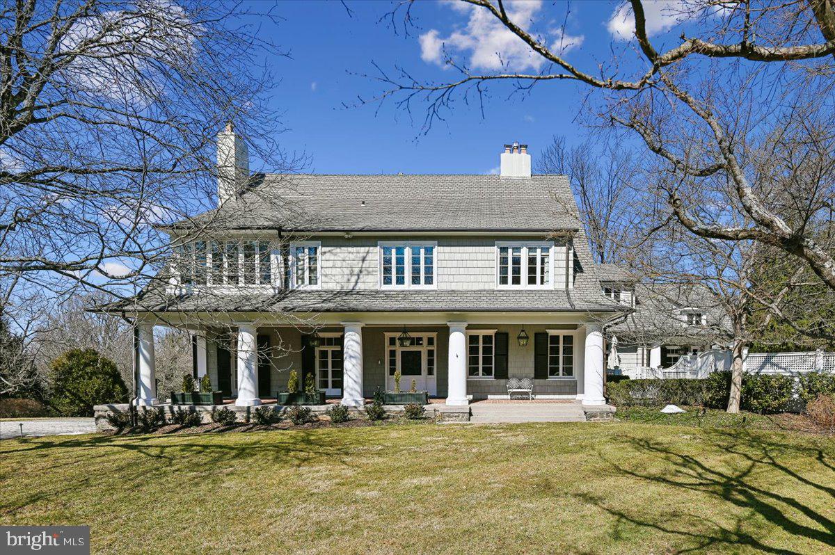 Wow, wow wow!  New Price!  Discover the pinnacle of Ruxton with this beautiful estate, situated on 1.5 lush acres. This home welcomes with a stately tone of timeless elegance. Meticulously renovated with a discerning eye, ensuring that no detail was spared; it is a masterpiece of modern luxury and craftsmanship. The journey begins in the gracious foyer that is anchored by warm hardwood floors & custom moldings.  A grand staircase leads the eye upward, framed by a multi-pane window that floods the entry with natural light. The foyer flows into a formal LR that feels both expansive & intimate. The fireplace and sun-drenched interiors are a hallmark of this space & multiple sets of French doors lead to the front porch. The architectural quality continues into the formal DR. Gold-toned walls provide a backdrop for a fireplace and a crystal chandelier. Tall windows overlook the grounds and wide cased openings allow for an effortless transition to the foyer & kitchen. The library offers custom built-ins for a curated book collection and seamlessly integrate a media center above a fireplace. The heart of the home is a chef’s kitchen that blends professional-grade utility with custom finishes.  Showcased is the striking black-and-gold Lacanche range set against a marble backsplash. A center island with marble countertops and custom turned legs is complemented by a farmhouse sink, dual lantern pendants, and a coffered ceiling. This culinary hub flows into a breakfast area and a gallery hall, which doubles as a refined beverage center featuring custom cabinetry & illuminated hutches.  Adjacent to the breakfast area, an inviting den with custom cabinetry and media center. Further enhancements include a butler’s pantry boasting floor-to-ceiling storage along with a secondary walk-in pantry. A full bathroom completes the functionality of this wing which opens to the pool, allowing easy access into the home without disruption to the formal living areas.  Ascend the grand staircase to the primary suite, starting with a stately bedroom anchored by a fireplace. Awash in natural light from oversized windows and a private seating area for comfort. A dual sanctuary, featuring two separate bathrooms that offer distinct aesthetics & luxury. The first bathroom is defined by an octagonal layout wrapped in mahogany millwork and topped with a tray ceiling. There is a soaking tub, walk-in shower, and elegant vanity.  The second and equally sophisticated bathroom leans into a classic-inspired design. It boasts a marble vanity against gold-toned floral walls and elegant sconces. An arched opening leads to a walk-in shower. Between these two, an expansive dressing room with floor-to-ceiling mirrored wardrobes, a sitting area & ample organizational space.  Versatile living continues with two distinct suites. The first is a vibrant bedroom and a light-filled study. It is connected via a shared, updated bathroom to a second gracious bedroom. This suite boasts a private sitting room, where a wall of windows overlooks the tree-lined grounds.  This level is finished by a private office and dedicated laundry room.  The third level of the home provides a rec room with vaulted ceilings and a trio of windows with commanding views of the surrounding tree canopy. A 4th bedroom is a haven served by a well-appointed full bathroom. The exterior of the home is a stunning display of classic shingle-style, with a light grey facade accented by white trim &  traditional black shutters. A welcoming front porch stretches across the front elevation. Manicured grounds include a sweeping driveway that leads to a detached three-car + garage.  The backyard is a private oasis designed for outdoor living & entertaining. A bluestone terrace provides multiple areas for lounging and dining and a sleek rectangular pool is framed by stone coping and set within an emerald lawn. Privacy is paramount, provided by towering, evergreen hedgerows that creating a serene and secluded retreat.