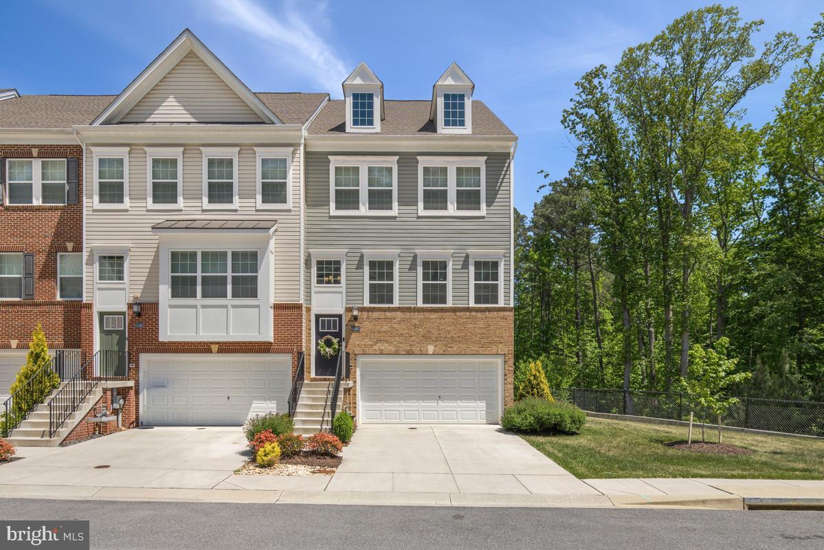 Welcome to this exceptional 3-bedroom townhome showcasing premium upgrades and refined finishes rarely found in neighboring homes. Thoughtfully designed with a bright, airy open-concept floor plan, this residence offers the perfect balance of luxury, comfort, and functionality.

The impressive gourmet kitchen is truly the centerpiece of the home, featuring elegant quartz countertops, a hugh center island with breakfast bar seating, classic subway tile backsplash, and high-end stainless steel appliances including a gas range and double wall oven. A spacious pantry and dedicated coffee/cocktail nook add both function and charm. The adjacent dining area is filled with natural light and opens to an elevated deck overlooking protected wooded area, creating a private outdoor retreat unmatched by many homes in the community.

The inviting family room flows seamlessly from the kitchen, making the space ideal for entertaining or everyday living. A convenient half bath completes the main level.

Upstairs, the luxurious owner’s suite stands apart with premium details including a tray ceiling, spacious layout, and a beautifully appointed ensuite bathroom featuring dual vanities and a frameless glass shower with built-in seating and shelf space. Two additional bedrooms, a full hallway bath, generous closet space, and a perfectly situated laundry nook complete the upper level.

The finished lower level continues to impress with hardwood flooring, a full bathroom, mudroom area, and an expansive flexible living space ideal for a media room, executive home office, fitness studio, or guest suite. A walkout leads to a stunning custom paver patio, creating an additional outdoor living area. 

Perfectly positioned on a premium corner lot backing to protected trees, this home offers a rare level of privacy and outdoor enjoyment. The combination of the elevated deck, custom patio, wooded backdrop, tray ceiling, frameless shower, hardwood lower level, and full lower-level bath are standout features that distinguish this property from neighboring homes.

Additional highlights include LeafFilter gutter guards and a spacious 2-car garage. This is not simply another townhome—it is a thoughtfully upgraded, premium residence designed for buyers seeking something truly exceptional.