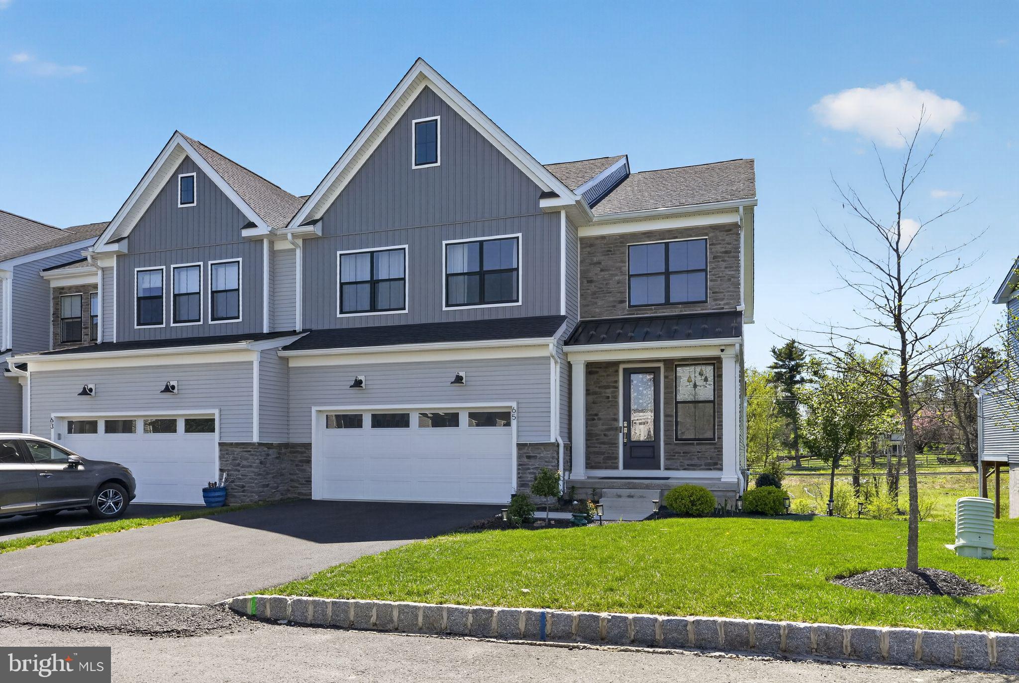 Stunning End-Unit Luxury Carriage Home in Doylestown Walk – Move-In Ready!

Experience the perfect blend of elegance, comfort, and modern design in this almost-new end-unit carriage home located in the highly sought-after Doylestown Walk community. Built by Toll Brothers, this exceptional Derby Elite floor plan offers over 4,000 square feet of beautifully finished living space, including a fully finished walk-out basement.

Step into a dramatic two-story foyer featuring upgraded 8” wide luxury plank flooring that flows throughout the main level. The open-concept layout is filled with natural light and designed for both everyday living and entertaining. The expansive family room seamlessly connects to a chef’s dream kitchen, complete with upgraded soft-close cabinetry, mosaic tile backsplash, and an impressive 12’ x 4’ quartz island with seating and designer pendant lighting.

The gourmet kitchen is equipped with high-end appliances, including a 36” six-burner JennAir gas range with hood, double ovens, farmhouse undermount sink, and a French-door Samsung refrigerator with customizable panels. A spacious dining area overlooks the backyard, while a large pantry and functional mudroom-style entry through the garage for added everyday convenience. The main level also includes a powder room and access to the oversized 2-car garage.

Upstairs, a wide oak staircase with craftsman-style railing leads to a versatile loft—perfect for a home office, media room, or play space. The luxurious primary suite is a true retreat, featuring abundant natural light, recessed lighting, ceiling fan pre-wire, and a spa-inspired en-suite bath with dual vanities, elegant tile flooring, a walk-in shower with seating, and a generous walk-in closet with attic access.

Two additional spacious bedrooms offer ample closet space and natural light, complemented by a full hall bath. A convenient second-floor laundry room includes a washer, dryer, and utility sink. Plush upgraded carpeting and padding extend throughout the upper level.

The fully finished walk-out basement  provides exceptional additional living space—ideal for entertaining, a home theater, or gym—and includes a 3-piece rough-in for a future bathroom, along with abundant storage.

Additional highlights include 9-foot ceilings on all levels, central water filtration system, and outdoor access to the backyard and side yard—perfect for gardening or relaxing. Inside annd outside cameras on the property.

Located just minutes from downtown Doylestown, this home offers the perfect balance of peaceful community living with easy access to shopping, dining, and major commuter routes.