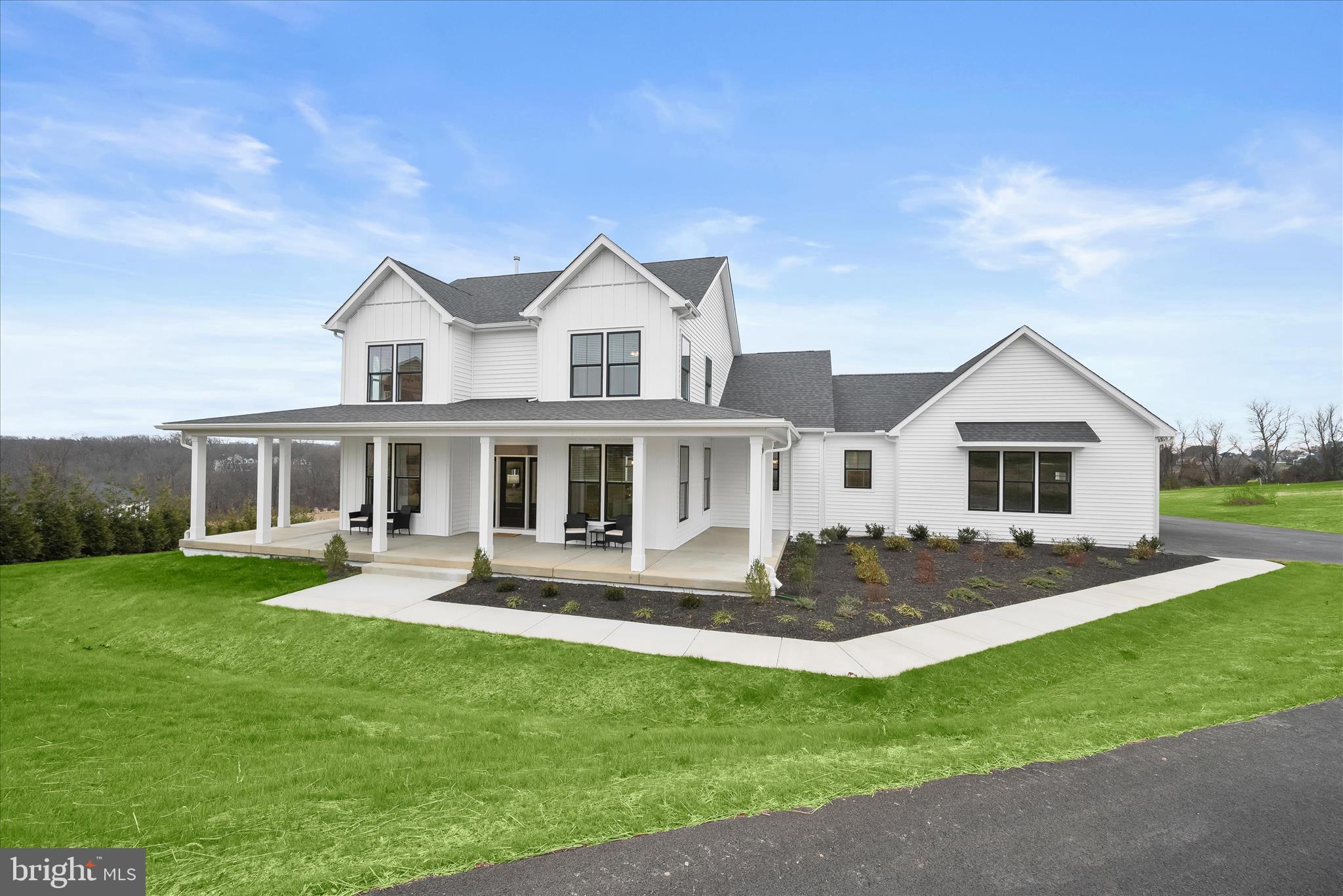 Introducing this exceptional brand new Georgia model by Greenspring Homes in Shamrock Estates, set on nearly two acres. Offering four bedrooms and three full bathrooms, this move-in ready home showcases high-quality finishes throughout. Tucked at the end of a long driveway, the property welcomes you with a covered wraparound porch and a convenient two-car garage. Inside, a modern neutral palette, tall ceilings, and abundant natural light create an inviting atmosphere. The foyer opens to beautiful hardwood floors, a formal dining room ideal for entertaining, and a spacious living room with a cozy gas fireplace. Prepare your favorite meals in the gourmet kitchen that is fully equipped with stainless steel appliances, quartz countertops, a tile backsplash, soft-close shaker cabinetry, and a center island. A breakfast nook offers space for casual meals, while the walk-in pantry adds excellent storage. A laundry room with built-in cubbies and garage access complete this side of the home. The main level hosts an exquisite primary bedroom suite with a walk-in closet and a spa-like bathroom featuring a dual-head walk-in shower, double vanity, linen closet, and separate water closet. A second bedroom and full bathroom are also on this level. Upstairs, you will find two additional bedrooms, a shared full bathroom, and two generous hall closets. The builder is offering a finished recreation room and bedroom in the lower level. Enjoy exceptional modern living in this brand-new home designed with comfort, style, and functionality in mind. Builder to include a recreation room, bedroom and bathroom in the lower level!