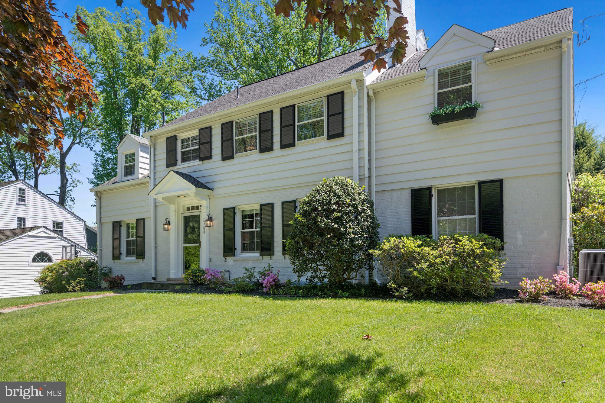 Welcome 5708 Overlea Road, located in the highly sought-after neighborhood of Sumner! Set on a flat quarter of an acre lot, this expanded home features five bedrooms and four full baths and a half bath on the main level.   The classic white exterior is highlighted with black shutters and charming window boxes is the ideal combination of space, layout and updates that lead to easy living.
 
The warm, bright living room is generously sized with a wood-burning fireplace surrounded by built-ins. Off the foyer is the home’s office/library with access to the half bath which could double as a main level bedroom. The flowing floorplan leads you to the entertainers sized dining room and rear family room with walls of windows overlooking the rear garden and access to the large deck.  The updated eat-in kitchen is flanked with a generous amount of cabinet space, quartz countertops, stainless appliances, new flooring and a charming breakfast area direct access to the large deck and the amazing, flat backyard, perfect for indoor/outdoor entertaining. The professionally landscaped rear yard and gardens are a true highlight of the home, with a large open grassy area, perfect for a game of catch, and a custom Rainbow playset.  Upstairs are four spacious bedrooms and three full baths. Both hall bathrooms have been updated and the rear bedroom is highlighted by a Juliet balcony overlooking the yard.  The upper level also has access to the expansive floored attic space via pull-down stairs.  The king-sized primary suite features a large dressing room leading to a walk-in closet as well as the primary bathroom with double vanities, a separate soaking tub, glass enclosed shower and heated floors. The finished lower level is complete with a family room space, a separate playroom area, the home’s fifth bedroom, currently being used as an exercise room, the home’s fourth full bath, the laundry room and plenty of storage. A one car garage and driveway parking for two cars round out this beautiful offering. Welcome home!