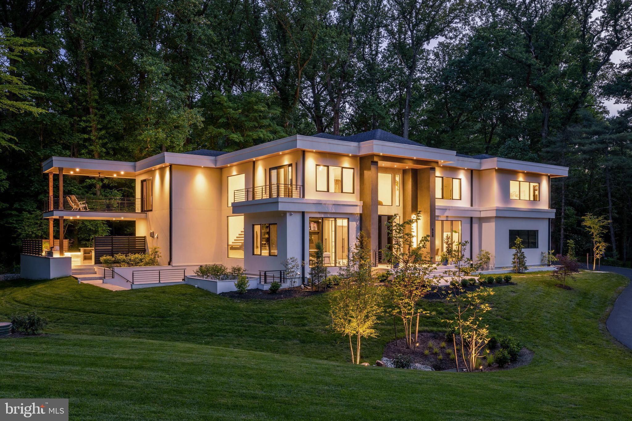 Welcome to 7841 Old Dominion Drive, the latest custom home project lovingly built by acclaimed local builders, EV Custom Homes. Gracefully perched above leafy Old Dominion drive, the home is bathed in sunshine. While contemporary with its clean lines and expansive windows, it is also warm and inviting with touches of golden wood tones and natural tile. With 11,400 SF of living space, there is room for independent comfort as well as joyful gathering. The open floor plan invites a comfortable flow for both easy family living and gracious entertaining. What truly distinguishes this home is the exquisite level of detail built into the home: Beautiful cabinetry designed in-house and made by local artisans creating a level of refinement and uniqueness. A showstopping glass and iron main staircase and iron back staircase, forged by local iron and glassworkers. Extensive and varied landscaping by a local landscape artist with crazy talent. Curated lighting (from high end vendors such as Eicholtz, Modern Forms, Visual Comfort, and Regina Andrews); wall coverings, unusual flooring and tile work, gorgeous hardware, a spectacular and unique front pivot door from Belgium, and more.  It is a home for the buyer looking for something that is far from ordinary; that you can move into and love. The home offers six spacious and sunny bedrooms each with its unique ensuite bath. The primary suite is an oasis. Enjoy the lush view over the pool from the huge balcony and expansive window line, fireplace, wet bar, and the adjacent spa like bathroom for that Zen vibe (with German made Badeloft fixtures and Porcelanosa tile), and a massive bespoke his and hers closet. Don't forget to check out the gorgeous handmade pocket door. The main level, with its open floor plan, ensures a seamless flow. The kitchen is a dream of modern serenity and function. All cabinetry was custom made with the finest materials, Dekton countertops, and a fabulous Wolf and Subzero suite, including the amazing Wolf steam oven which will revolutionize the way you cook. The family room will be the heart of the house, anchored by a dramatic marble slab fireplace, beautiful bespoke built in cabinetry, and a literal wall of glass bringing the outside in. Tucked away is a beautiful built-in bar positioned to keep the flow going on party nights or movie night The first and second levels also feature modern, seam free, plaster molding designed specifically for this house. The two-story mudroom is stunning - imported terrazzo flooring, a statement iron and glass entry door, large pantry, more custom cabinetry, back powder room, and a spacious catering kitchen for those serious cooks. Downstairs is an entertainer's delight: a spacious second family room or entertainment lounge with a knockout bar, fireplace, gym, sauna, a huge steam room for the whole gang, bedroom with an ensuite bath, and an open stairway leading to the outdoor kitchen and pool area. Downstairs as well is a fully finished bonus room that can be used a huge storage space or transformed into flex space such as a media room, art or music room, or whatever the need may be. Living well inside a home like this would not be complete without living well outside. Got you covered: a spectacular pool area with honed marble decking, heated pool and spa with an automatic cover, waterfalls, and color changing LED lighting galore. Enjoy evenings outside under the louvered pergola with a built-in concrete firepit. And of course, no outdoor entertainment area would be complete without a full, covered outdoor kitchen and bar. Other features include garages for 4 cars, elevator, generator, built-in speaker system on all levels, CAT 6 wiring, high end Reynaers windows and door from Belgium, security system, automatic gate, Legrande Adorne switches, double gas and electric water heaters, inground sprinkler system, extensive landscape lighting, and more. Wonderful McLean at its finest. Award winning public and private schools.